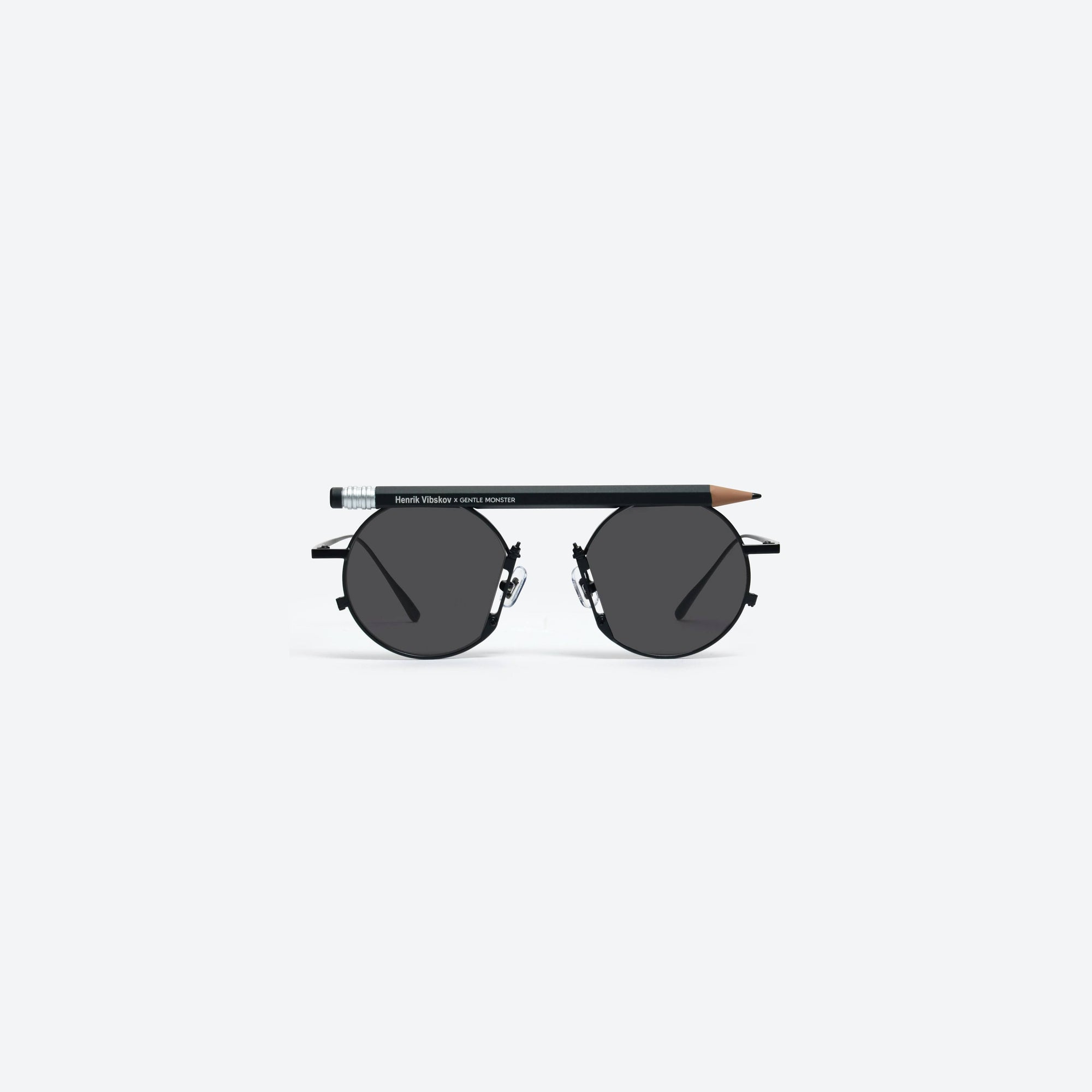 A front view of Gentle Monster Henrik Vibskov - Pencil Glasses Black Pen Black Metal framed Round sunglasses.