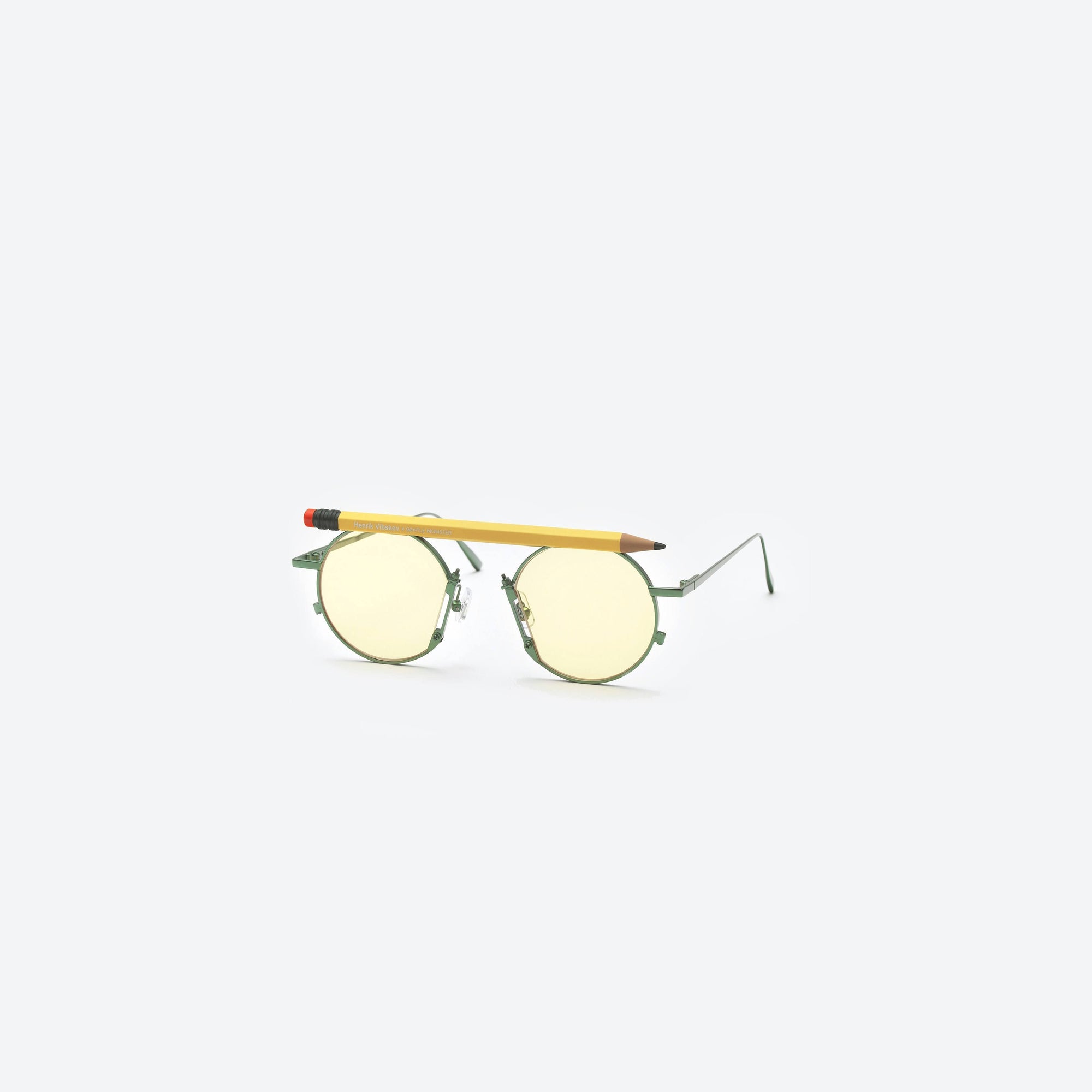 45-degree view of Gentle Monster Henrik Vibskov - Pencil Glasses Yellow Pen Green Metal framed Round sunglasses.