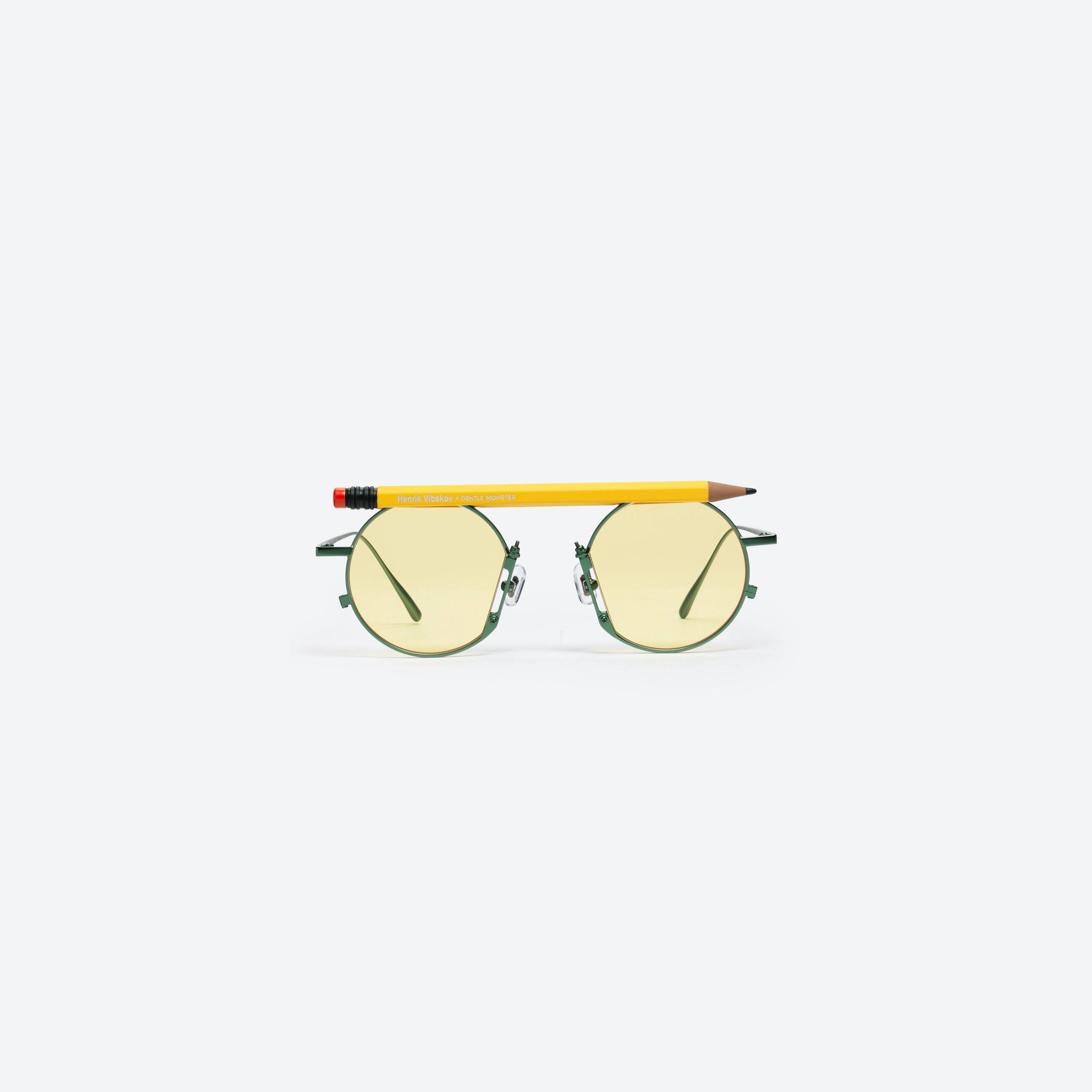 A front view of Gentle Monster Henrik Vibskov - Pencil Glasses Yellow Pen Green Metal framed Round sunglasses.