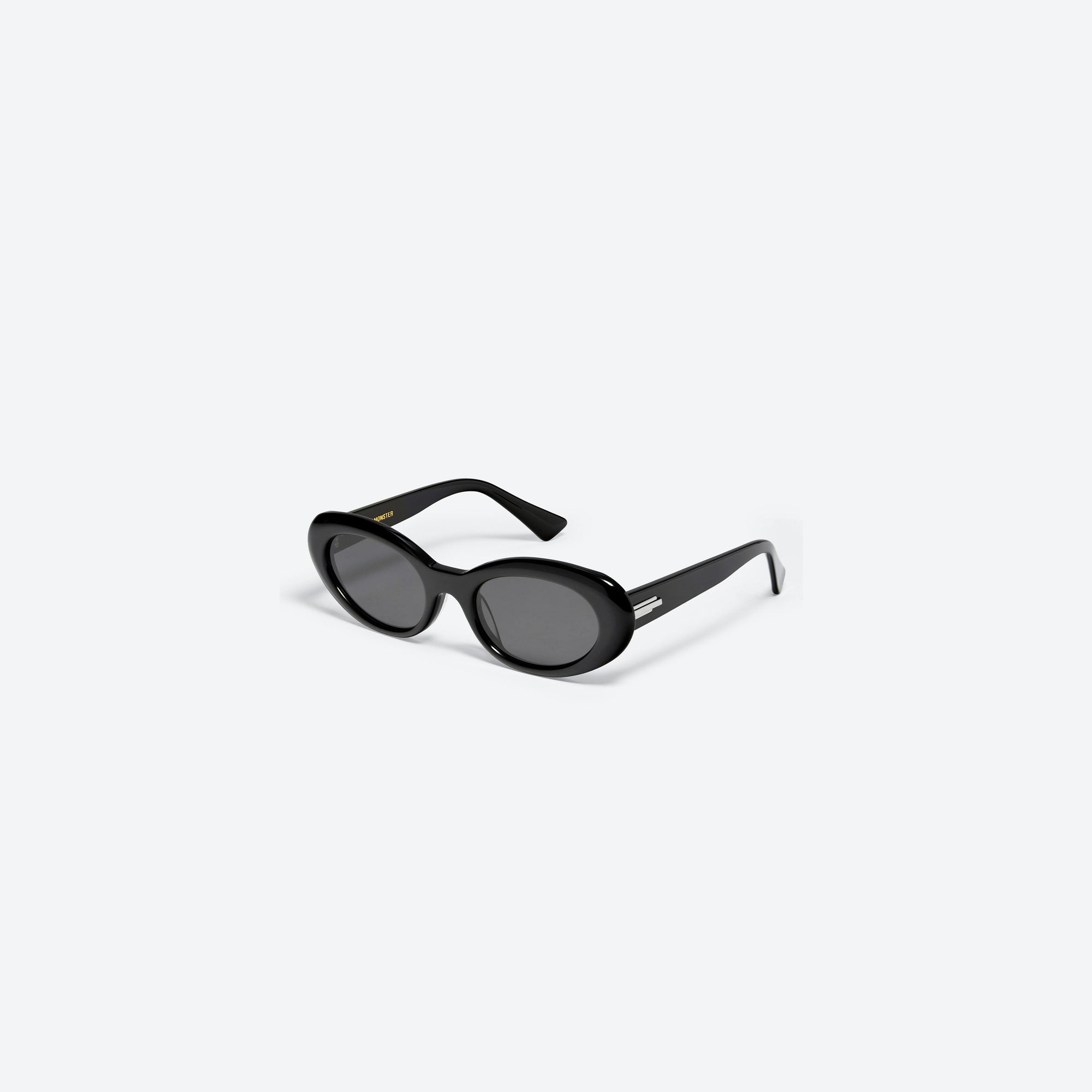 45-degree view of Gentle Monster Le 01 Black Acetate framed Oval sunglasses.