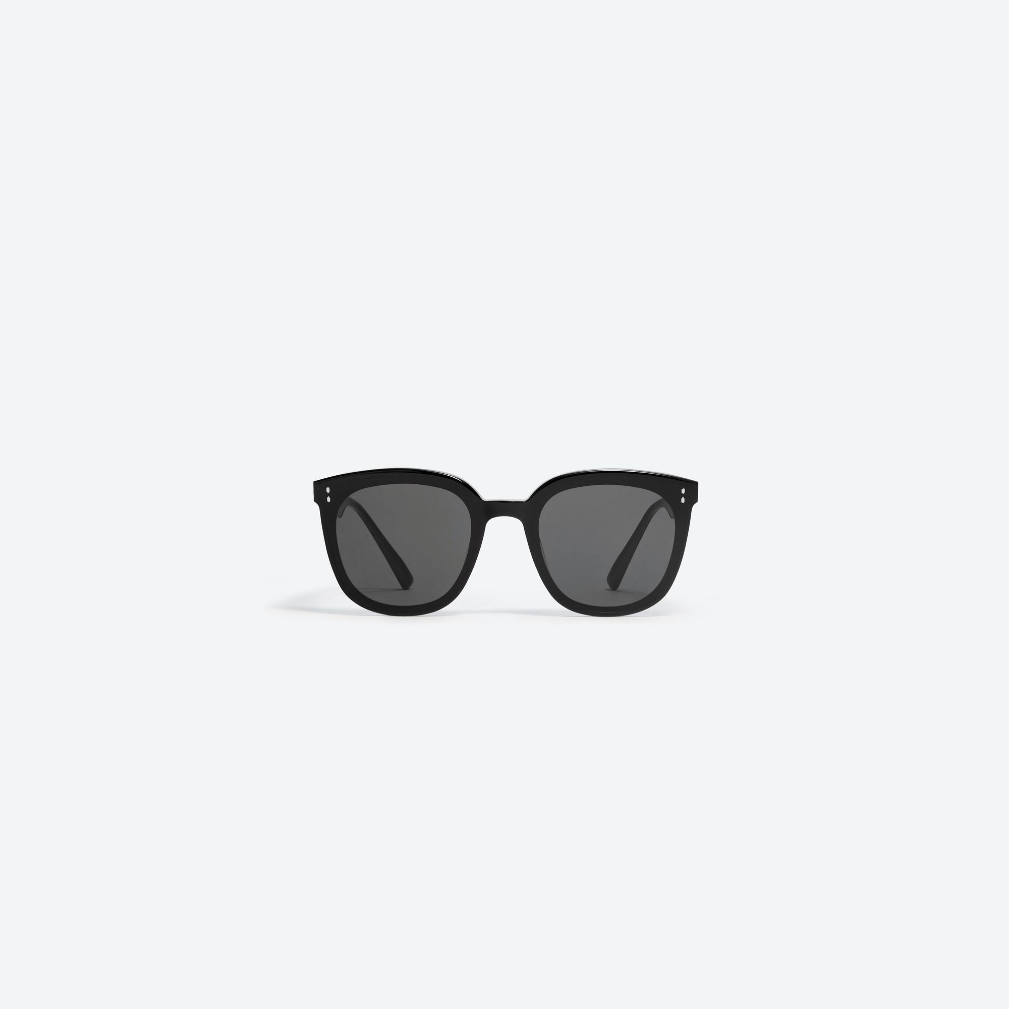 A front view of Gentle Monster Rosy 01 Small Black Acetate framed Round sunglasses.