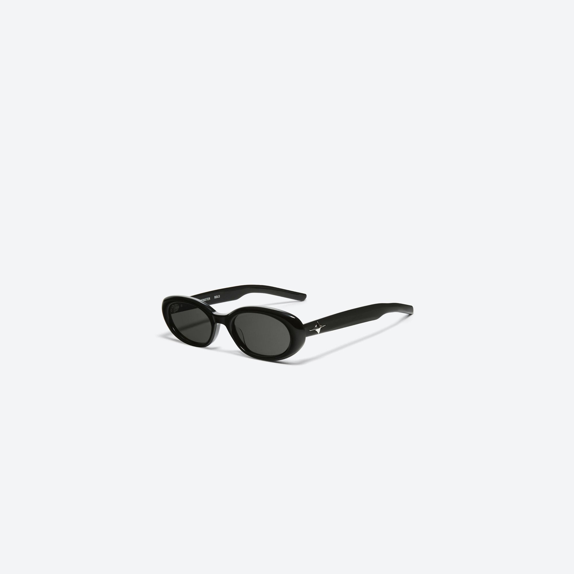 45-degree view of Gentle Monster Bandoneon.S 01 Black Acetate framed Oval sunglasses.