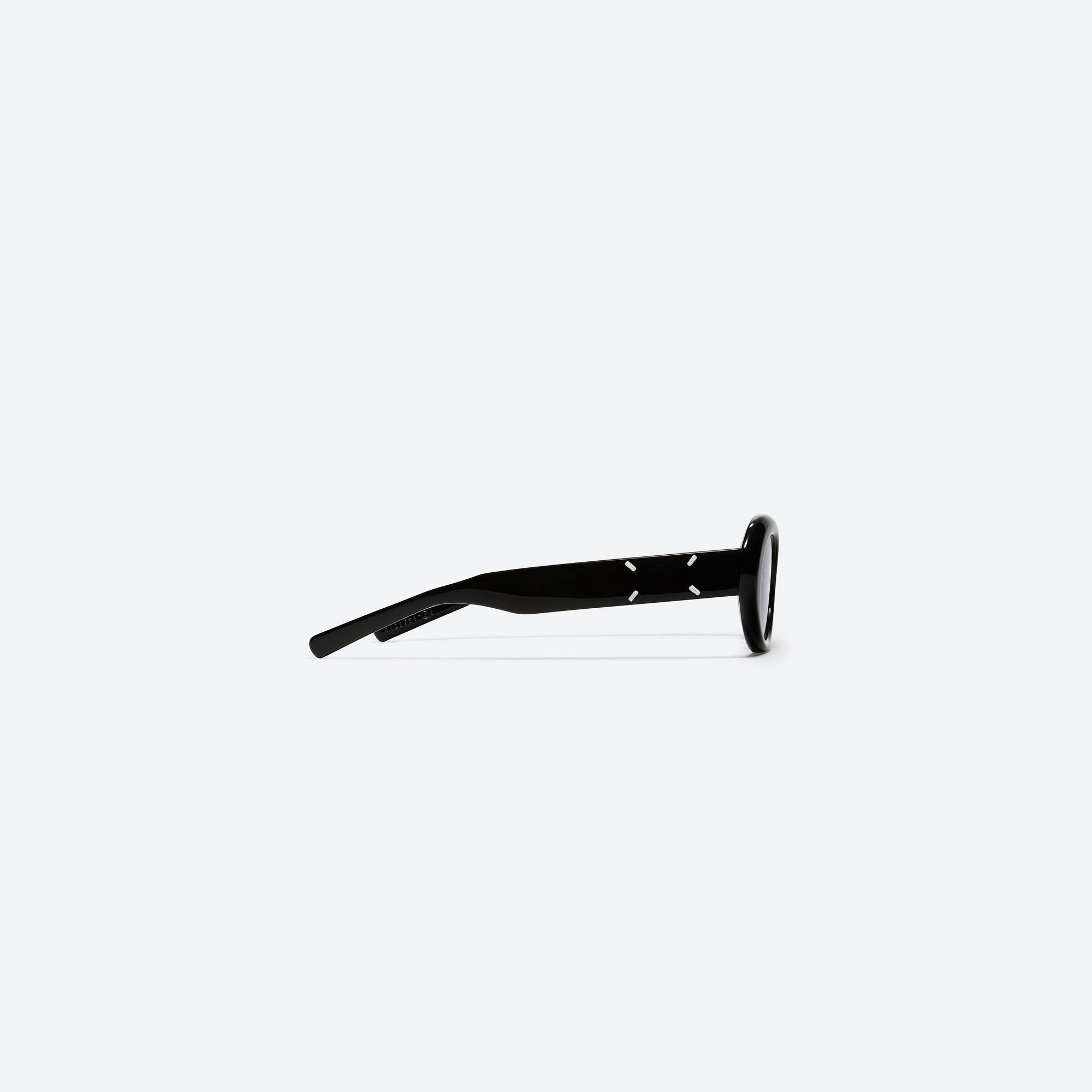 A detailed right view of Gentle Monster Maison Margiela - MM005 01 Black Acetate framed Oval sunglasses.