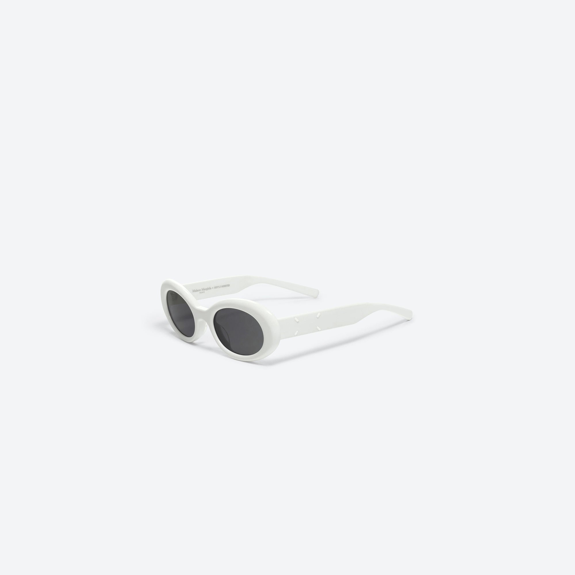 45-degree view of Gentle Monster Maison Margiela - MM005 W2 White Acetate framed Oval sunglasses.