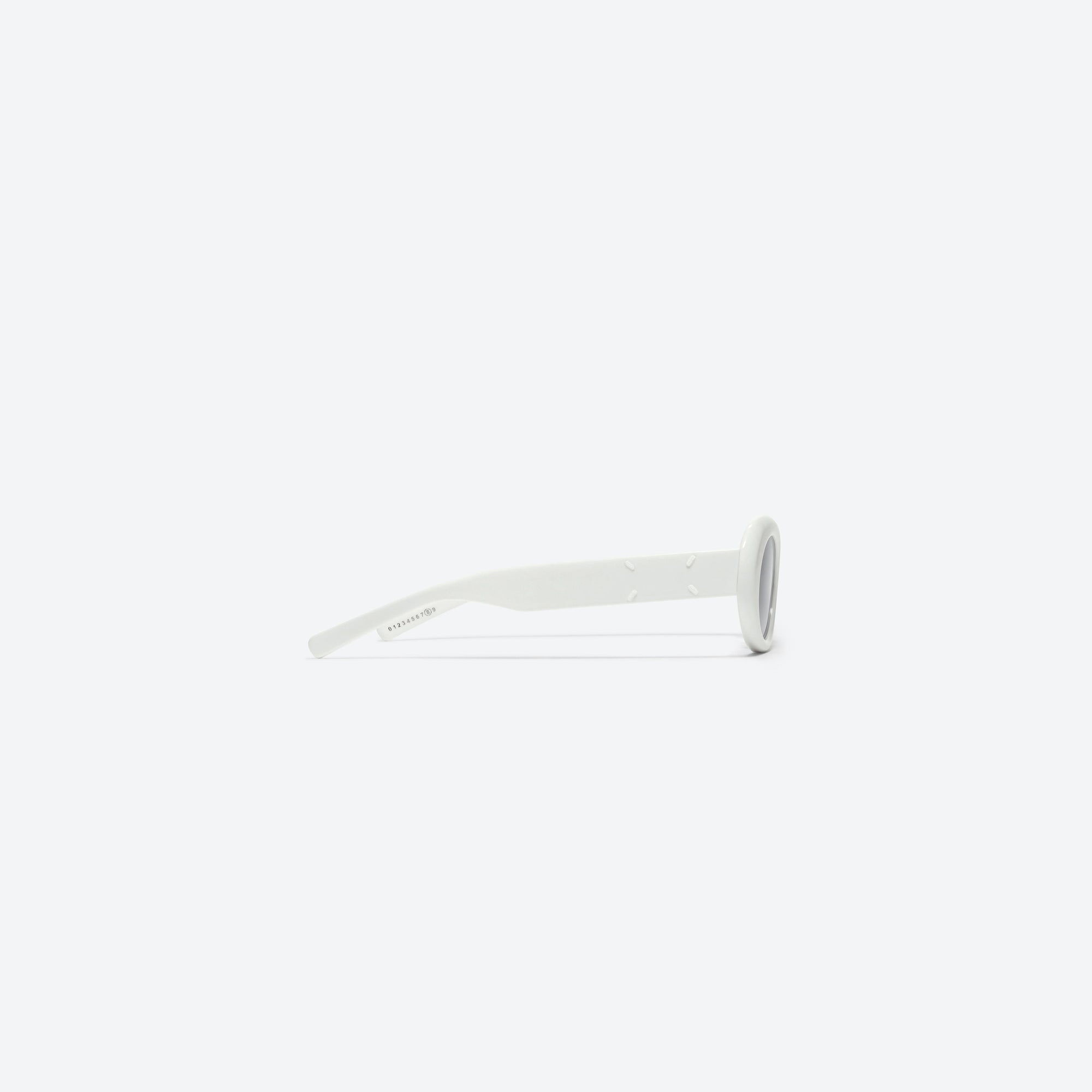 A detailed right view of Gentle Monster Maison Margiela - MM005 W2 White Acetate framed Oval sunglasses.