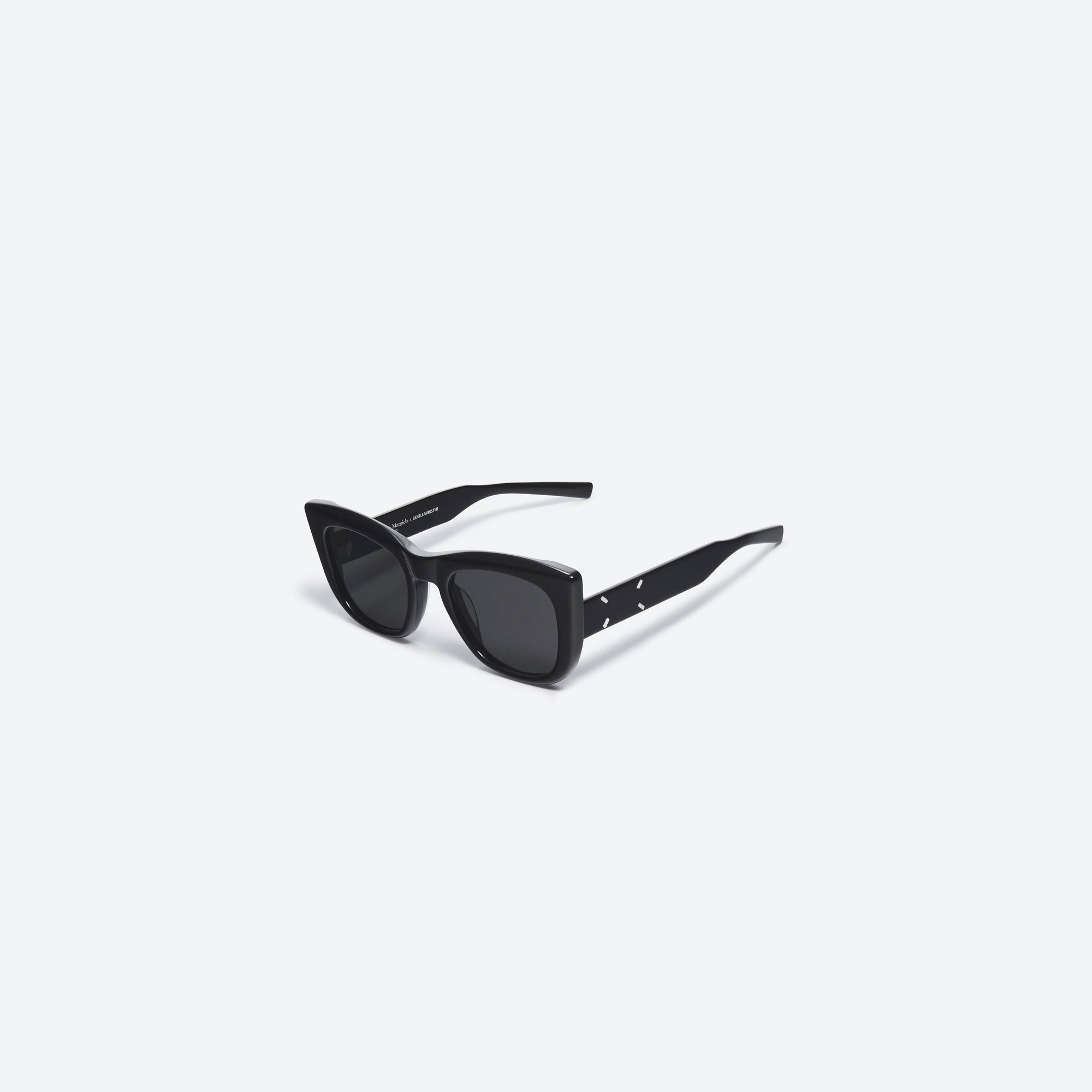 45-degree view of Gentle Monster Maison Margiela - MM008 01 Black Acetate framed Cat-eye sunglasses.