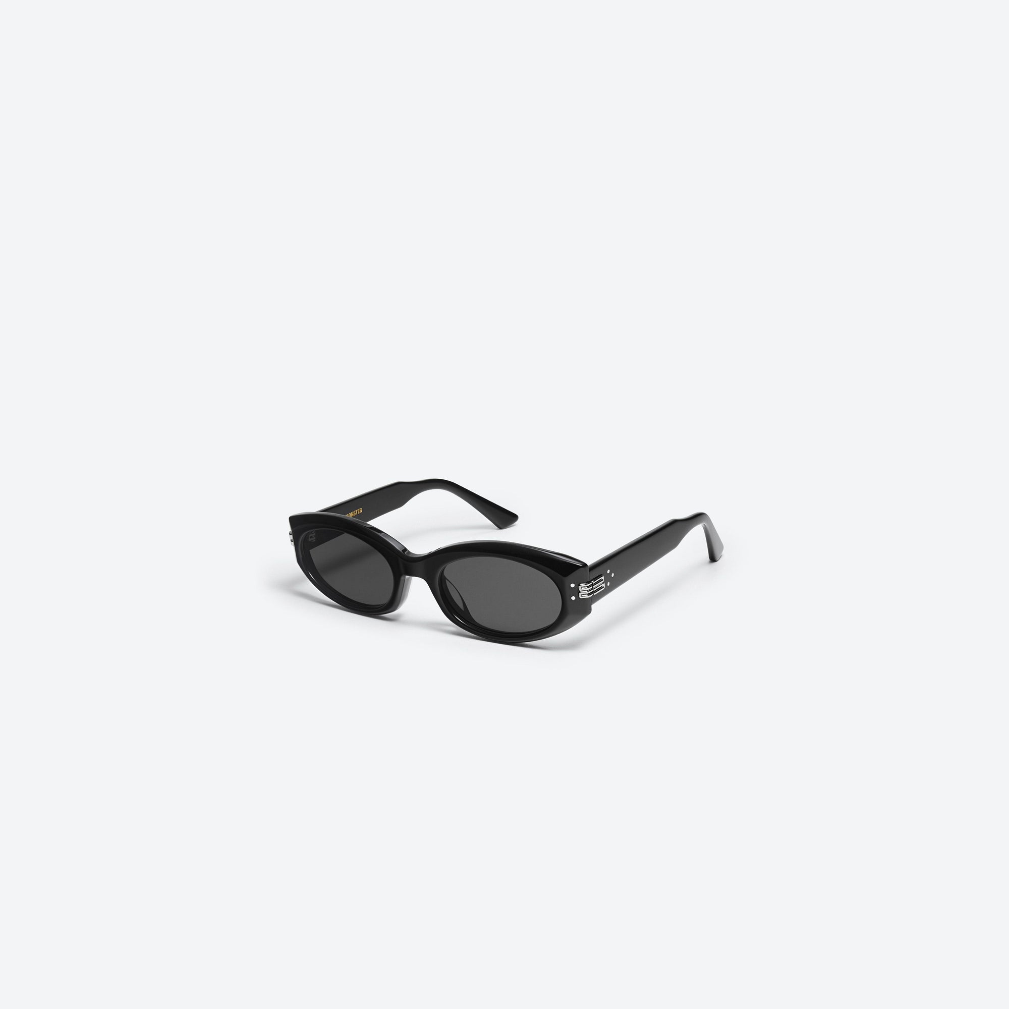 45-degree view of Gentle Monster Mass 01 Black Acetate framed Oval sunglasses.