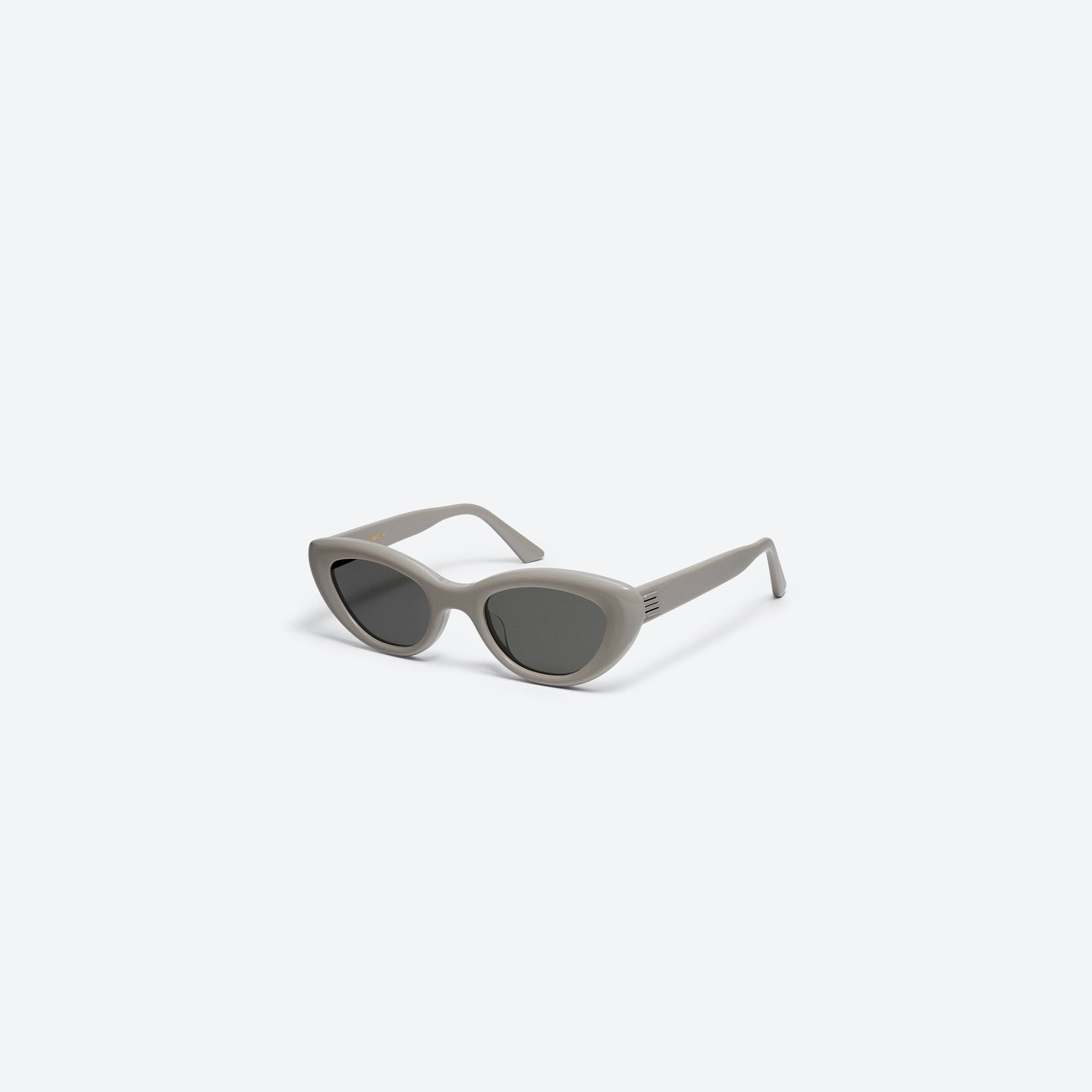 45-degree view of Gentle Monster Conic G10 Similar Gray Acetate framed Cat-eye sunglasses.