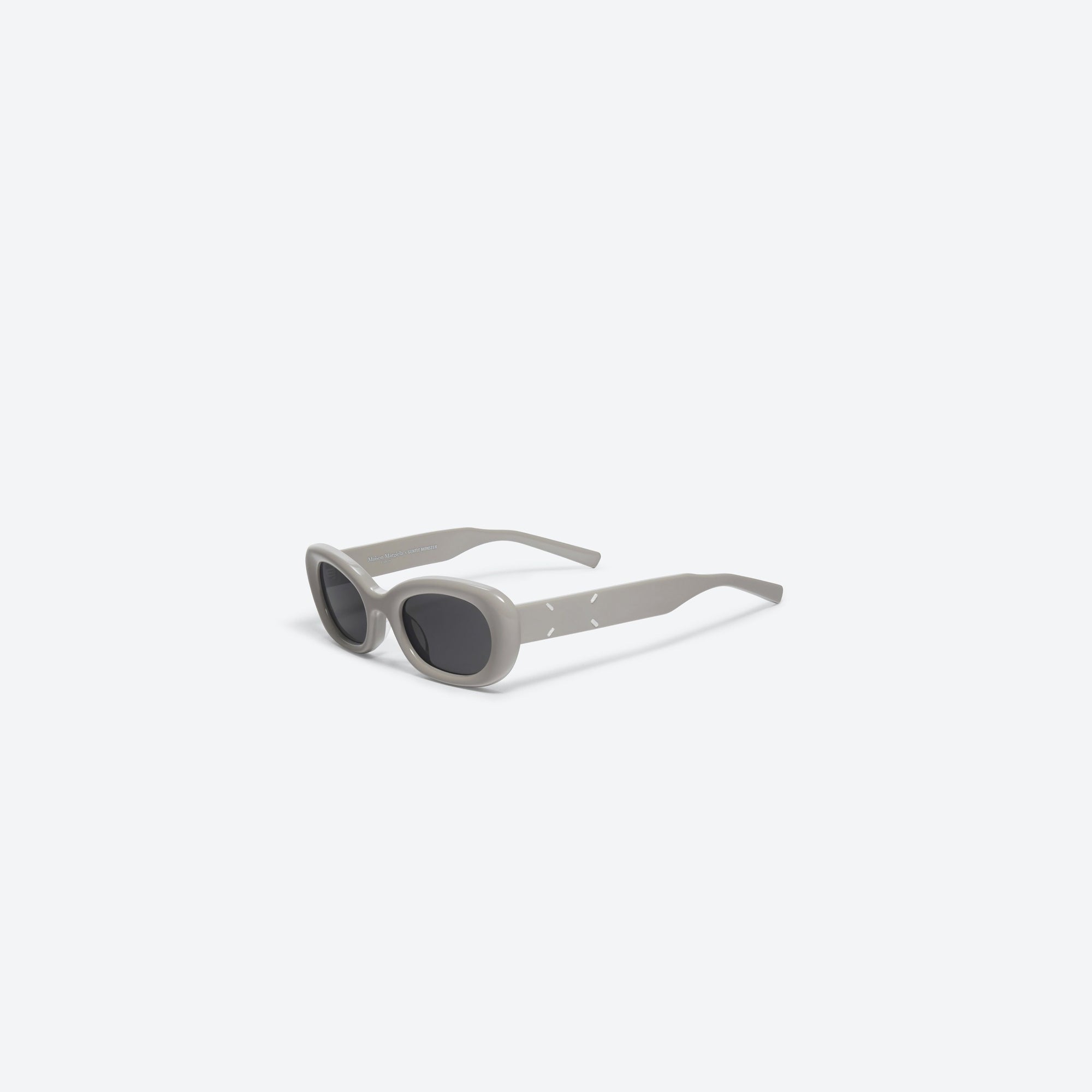 45-degree view of Gentle Monster Maison Margiela - MM004 G10 Gray Acetate framed Square sunglasses.