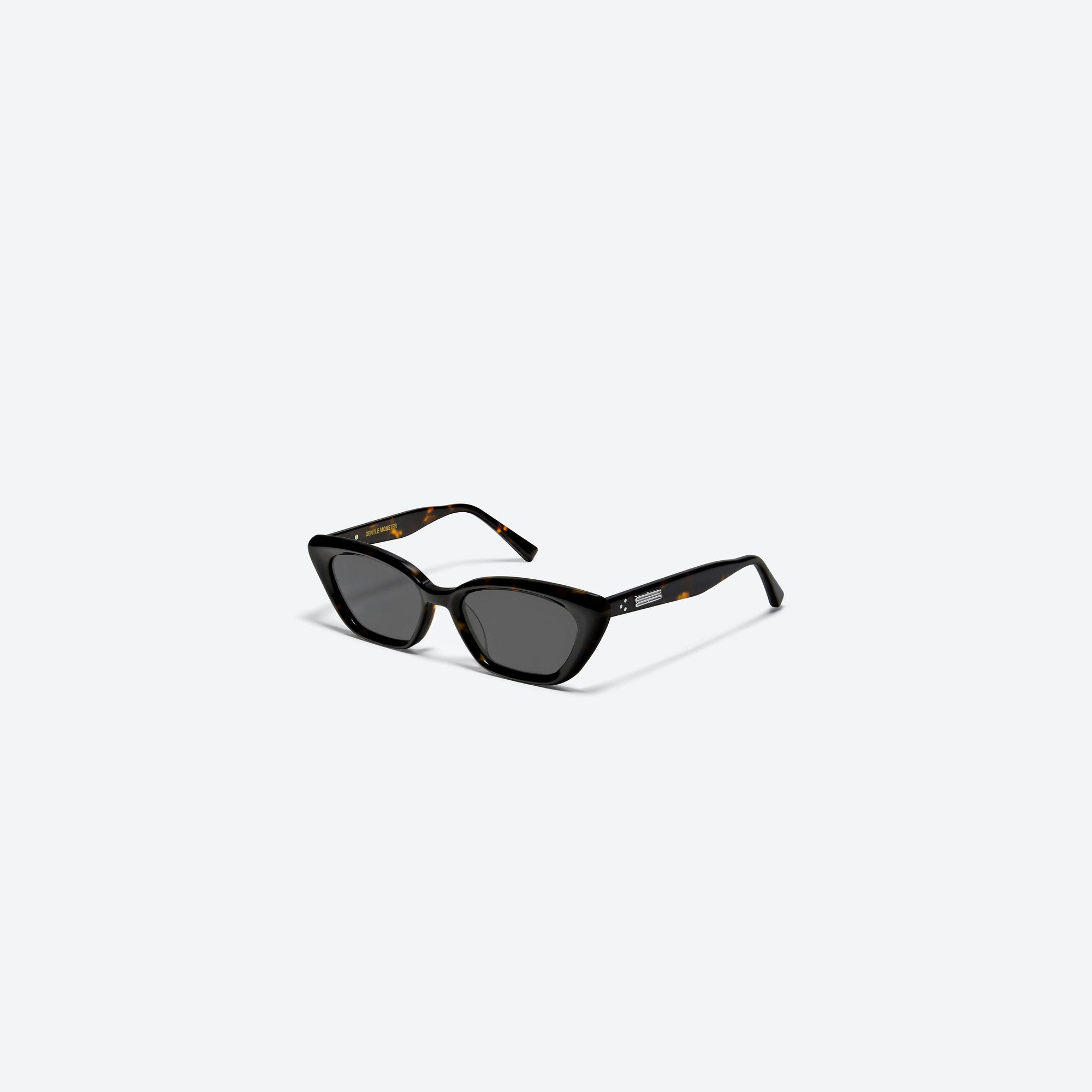 45-degree view of Gentle Monster Terra Cotta T1 Tortoise Acetate framed Cat-eye sunglasses.