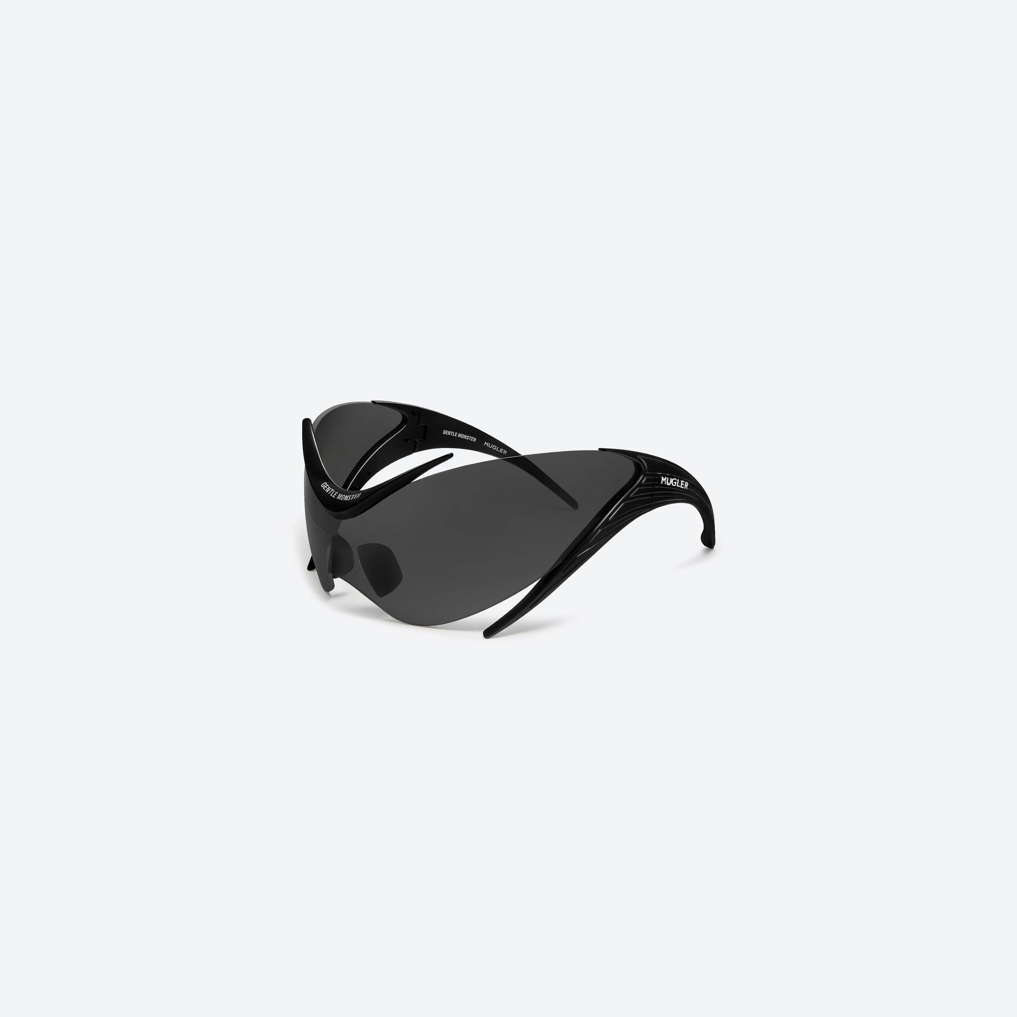 45-degree view of Gentle Monster Mugler - Spiral 01 M01 Black Nylon framed Wraparound sunglasses.