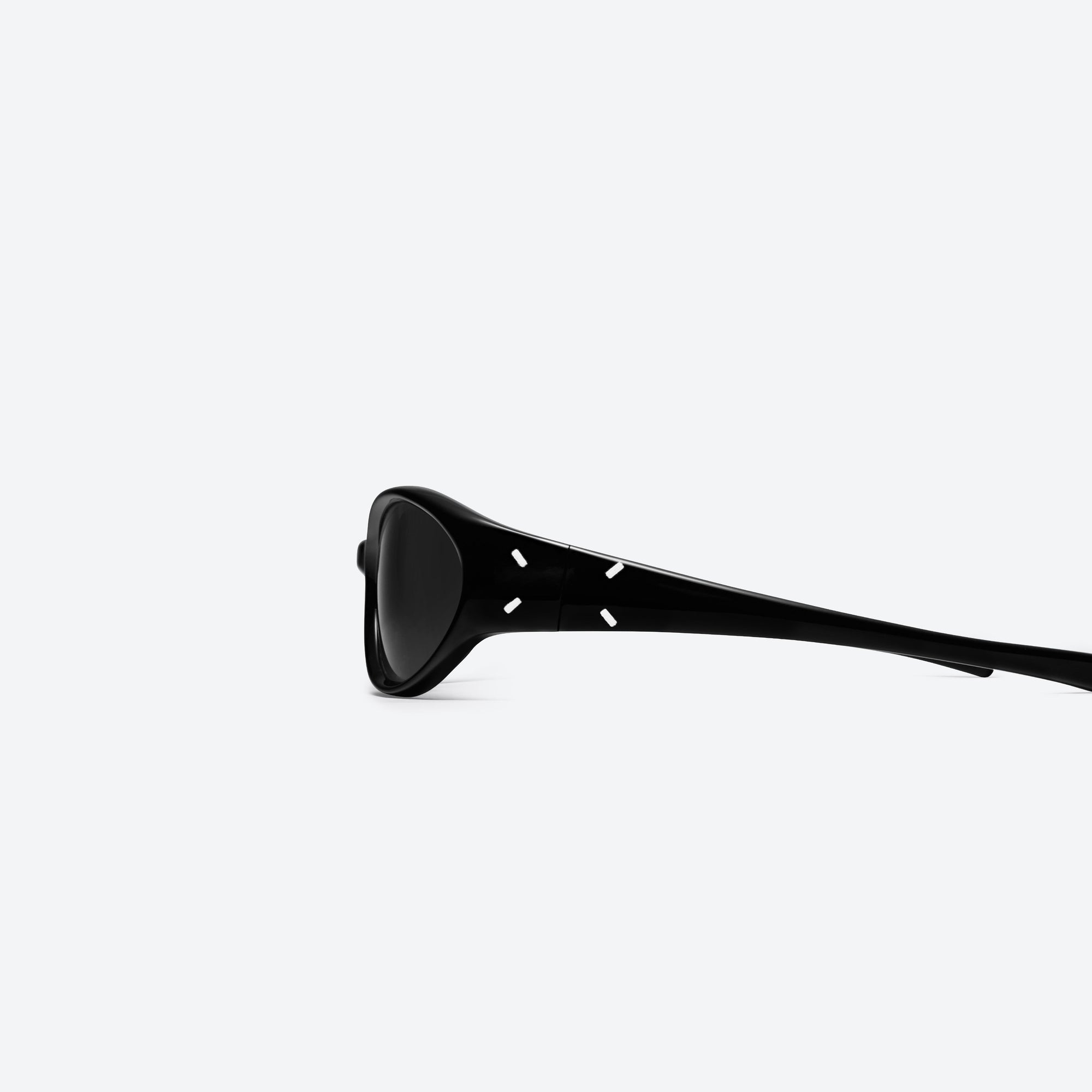 A detailed left view of Gentle Monster Maison Margiela - MM104 01 Black Acetate framed Wraparound sunglasses.