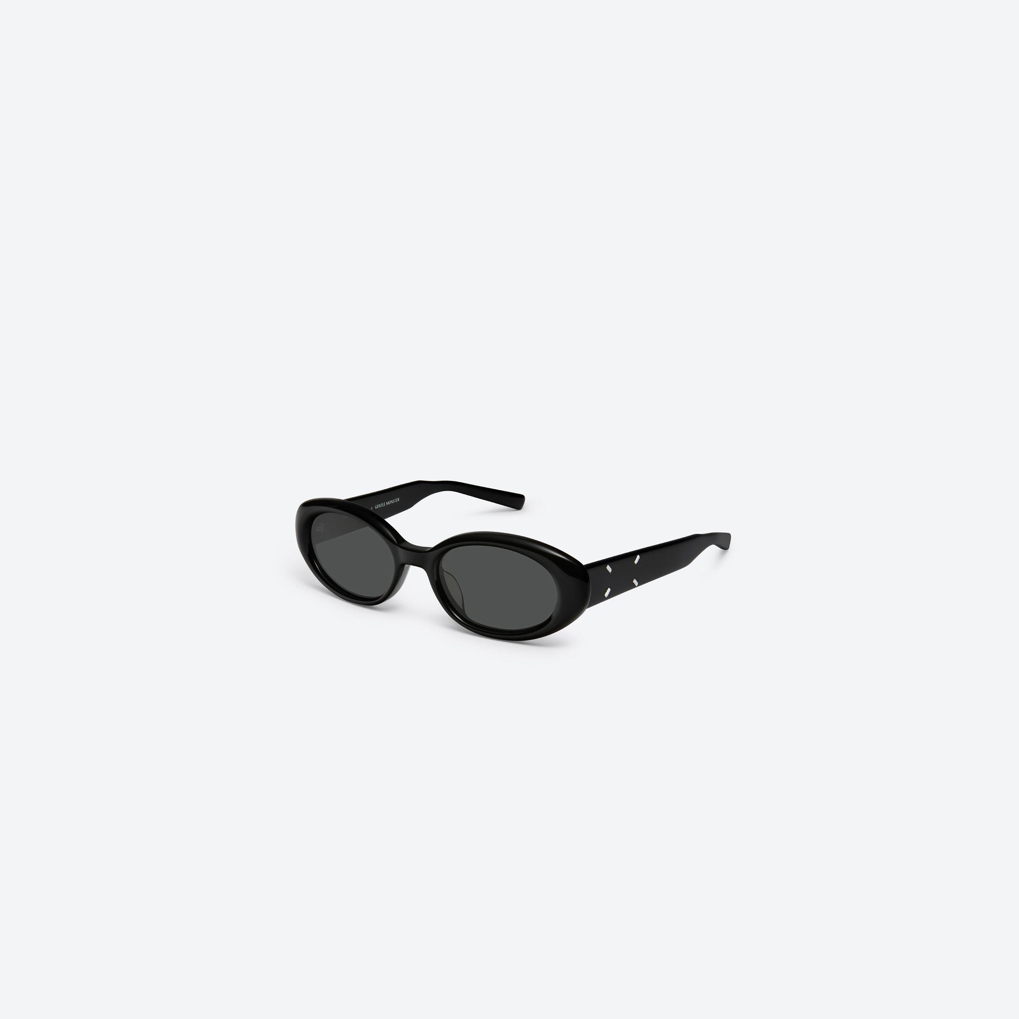 45-degree view of Gentle Monster Maison Margiela - MM107 01 Black Acetate framed Oval sunglasses.