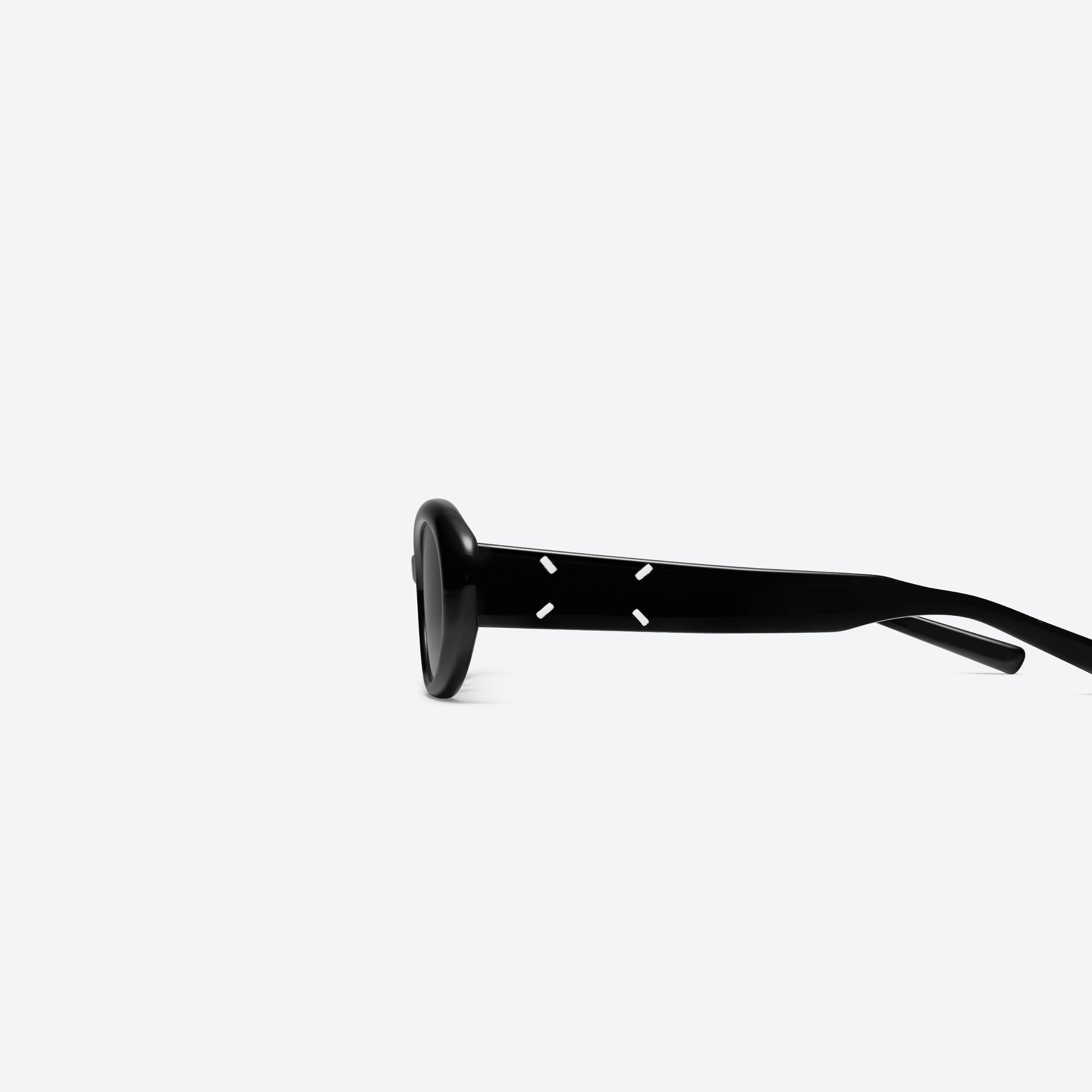 A detailed left view of Gentle Monster Maison Margiela - MM107 01 Black Acetate framed Oval sunglasses.