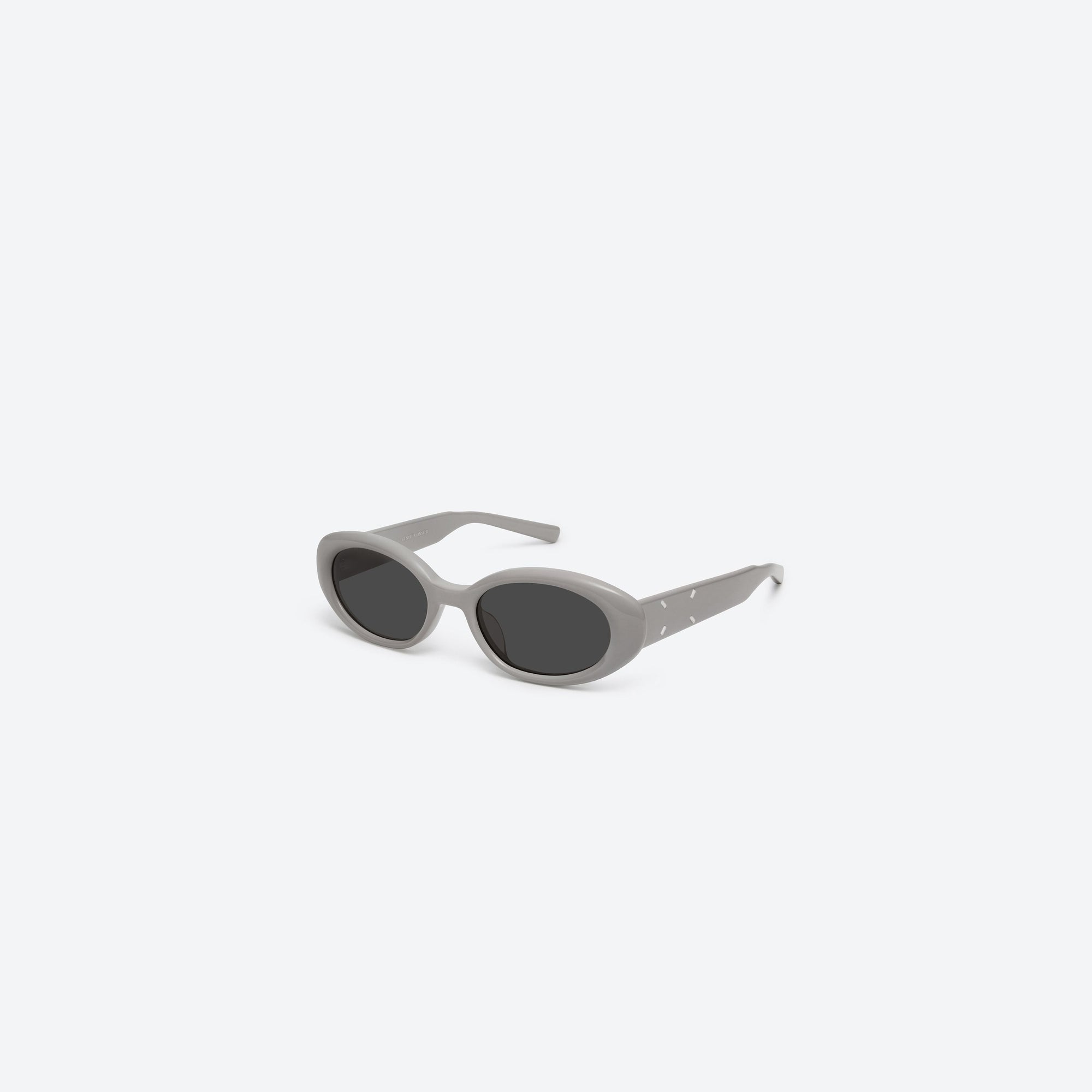 45-degree view of Gentle Monster Maison Margiela - MM107 G10 Gray Acetate framed Oval sunglasses.