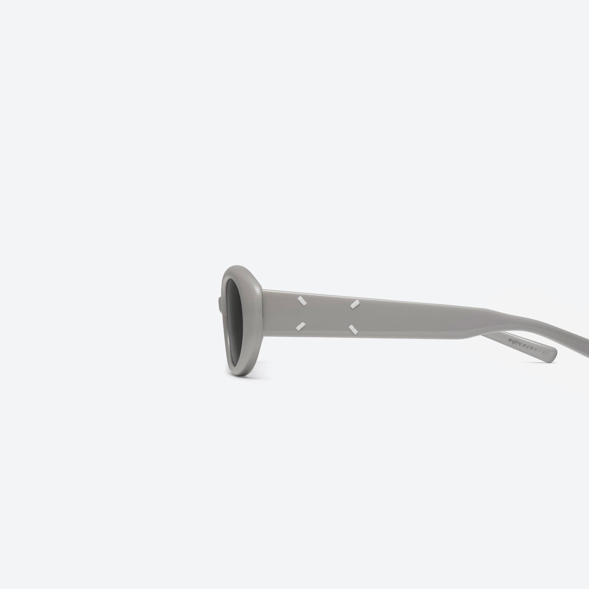 A detailed left view of Gentle Monster Maison Margiela - MM107 G10 Gray Acetate framed Oval sunglasses.