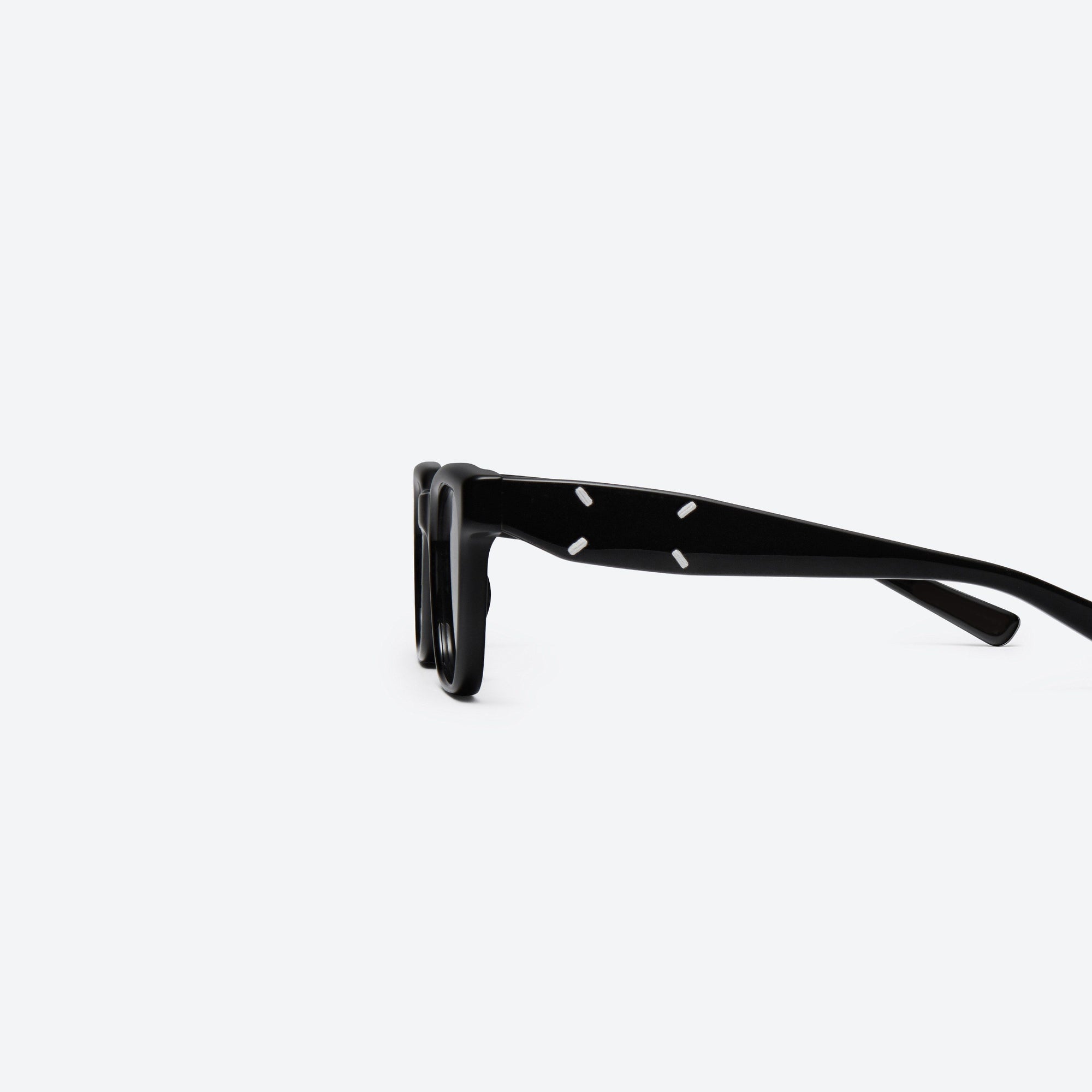 A detailed left view of Gentle Monster Maison Margiela - MM110 01 Black Acetate framed Square sunglasses.