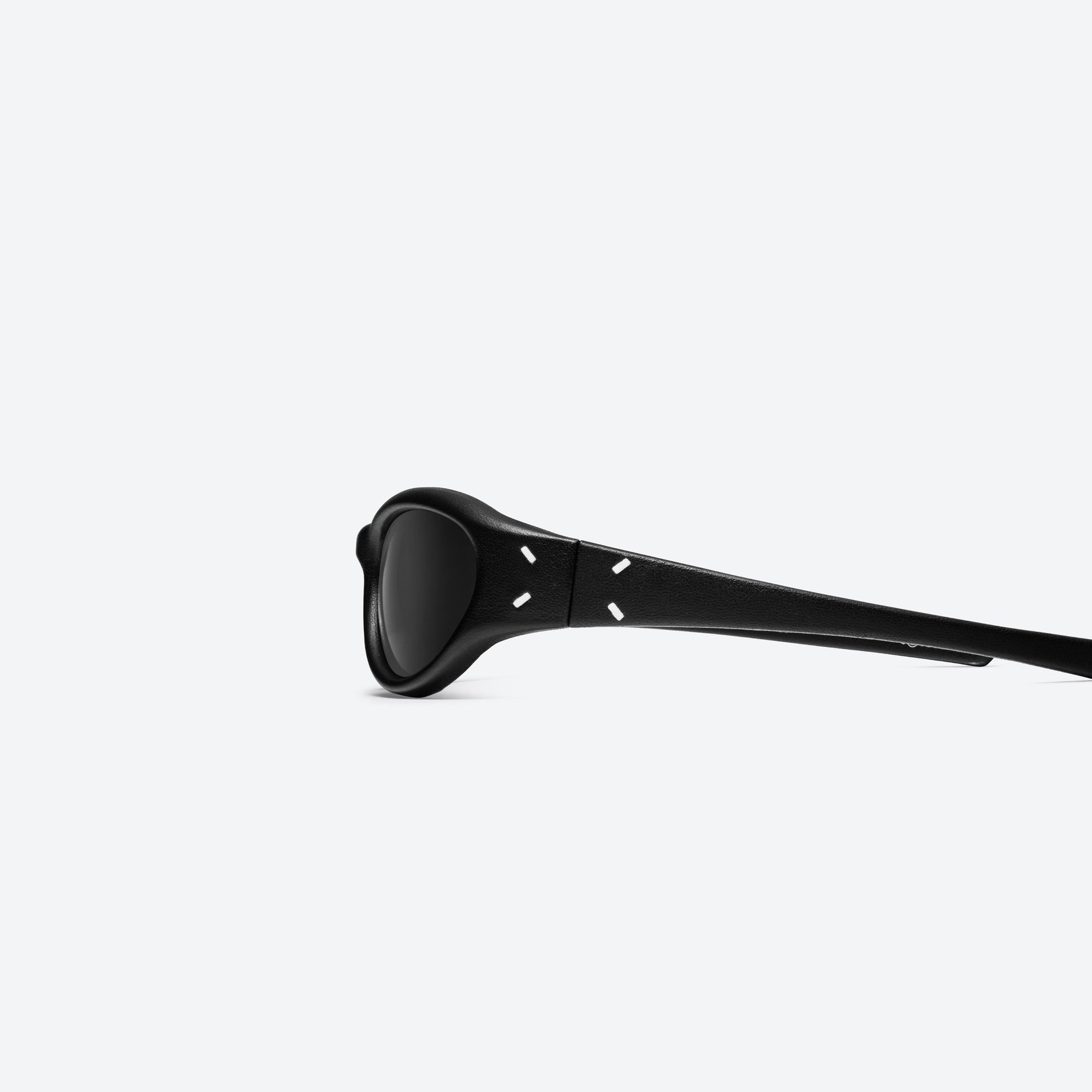 A detailed left view of Gentle Monster Maison Margiela - MM105 Leather L01 Black Acetate framed Wraparound sunglasses.