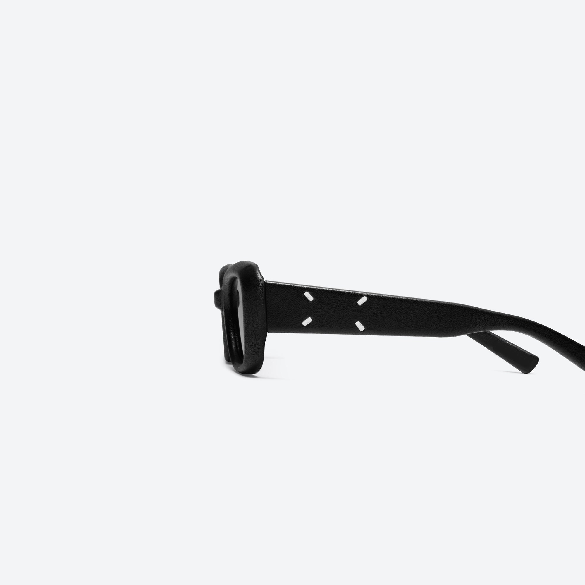 A detailed left view of Gentle Monster Maison Margiela - MM106 Leather L01 Black Acetate framed Square sunglasses.