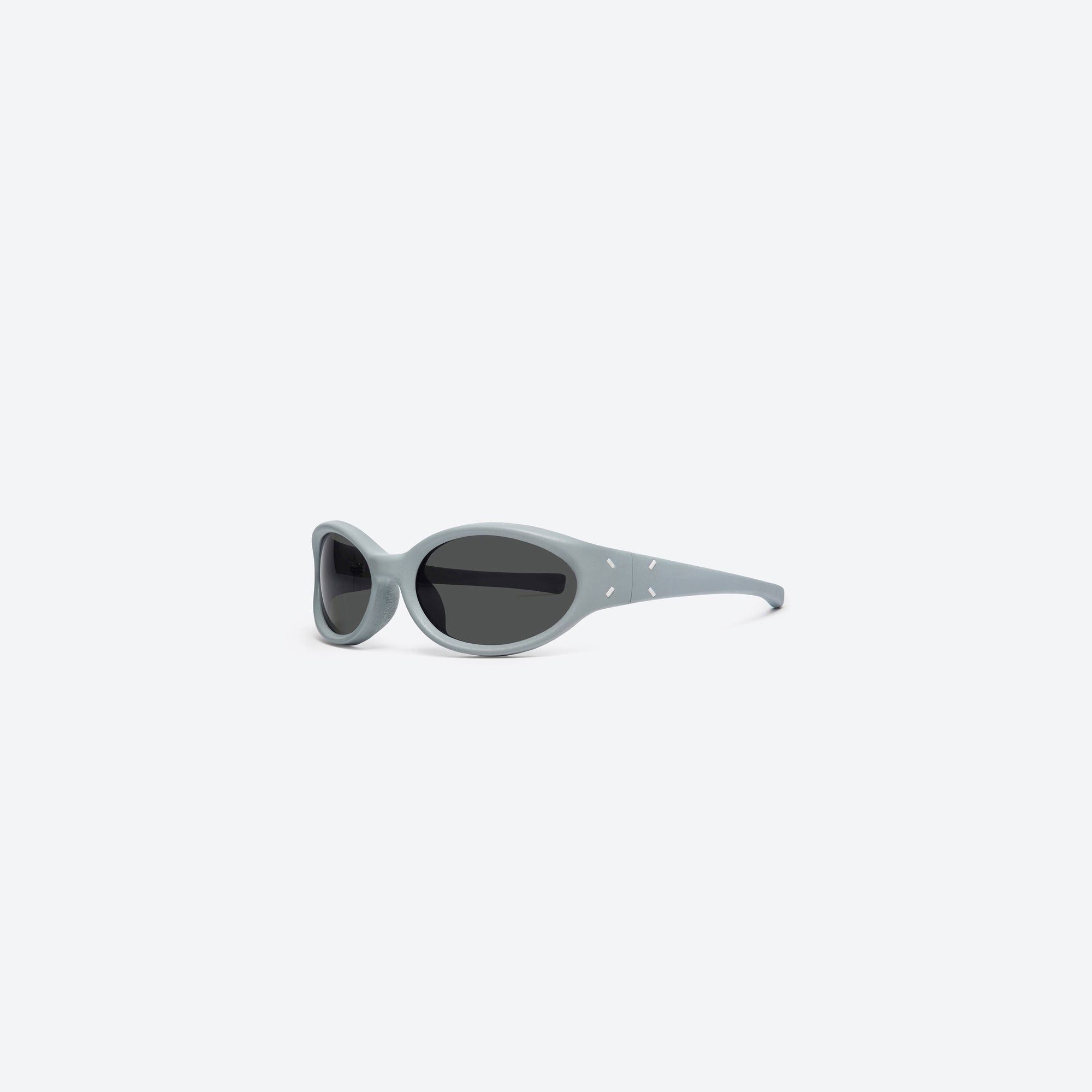 45-degree view of Gentle Monster Maison Margiela - MM104 Leather LBL1 Blue Acetate framed Wraparound sunglasses.