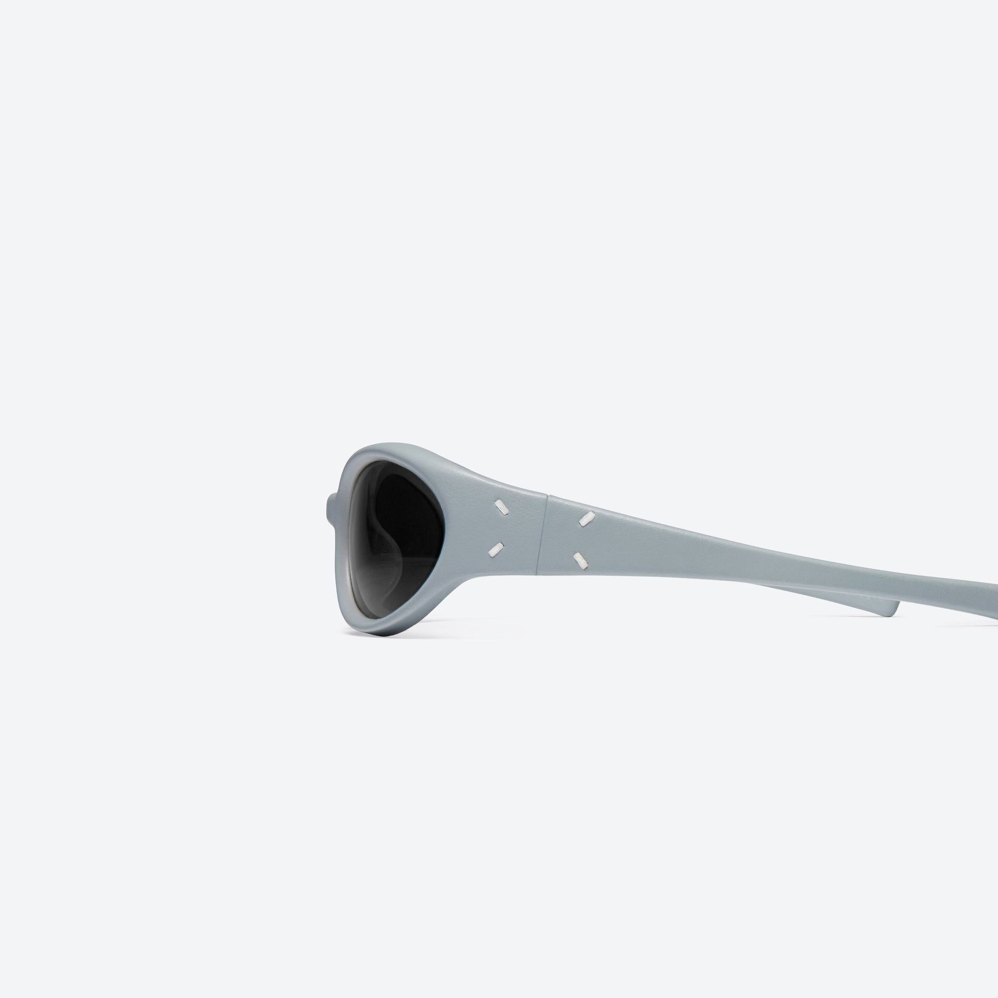 A detailed left view of Gentle Monster Maison Margiela - MM104 Leather LBL1 Blue Acetate framed Wraparound sunglasses.