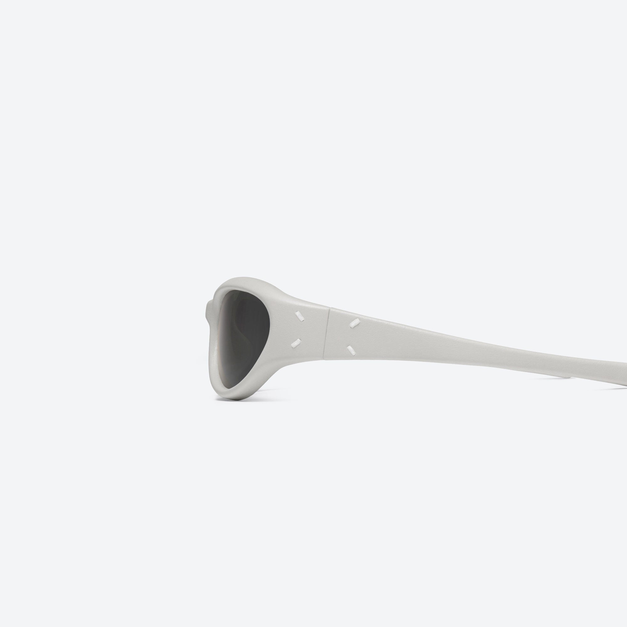 A detailed left view of Gentle Monster Maison Margiela - MM105 Leather LIV1 Ivory Acetate framed Wraparound sunglasses.