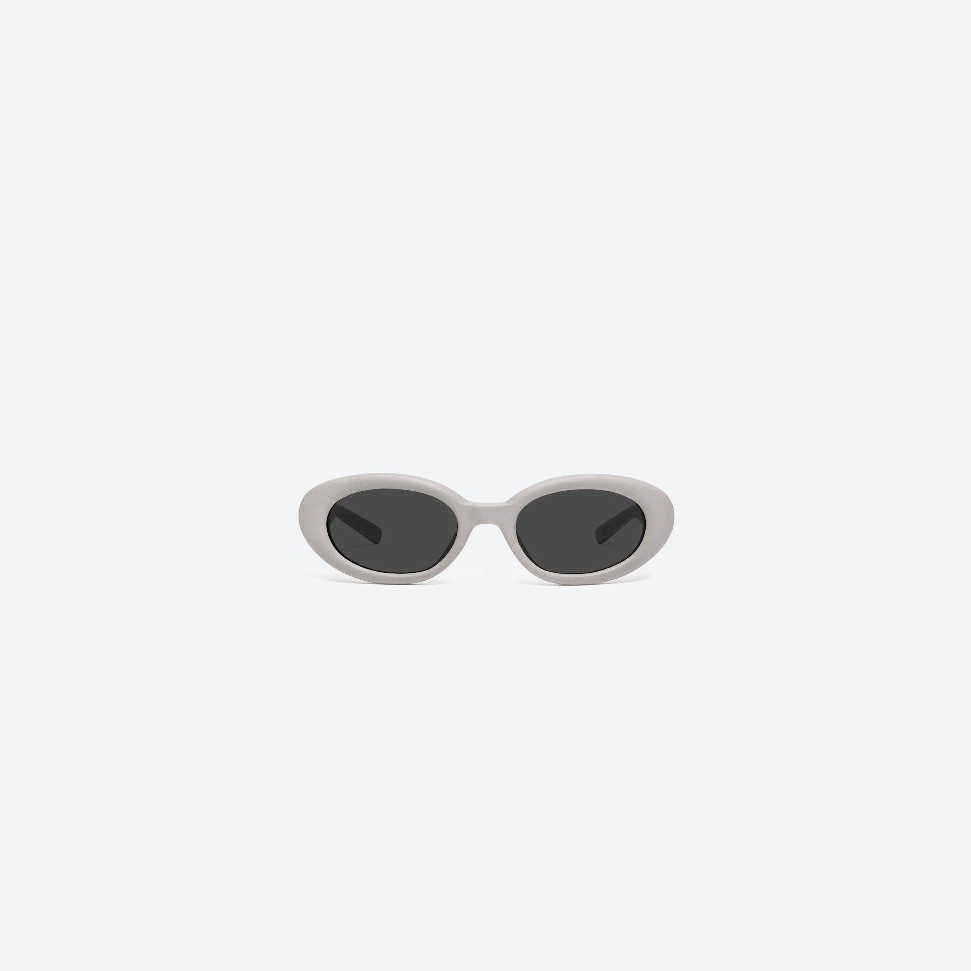 A front view of Gentle Monster Maison Margiela - MM107 Leather LIV1 Ivory Acetate framed Oval sunglasses.