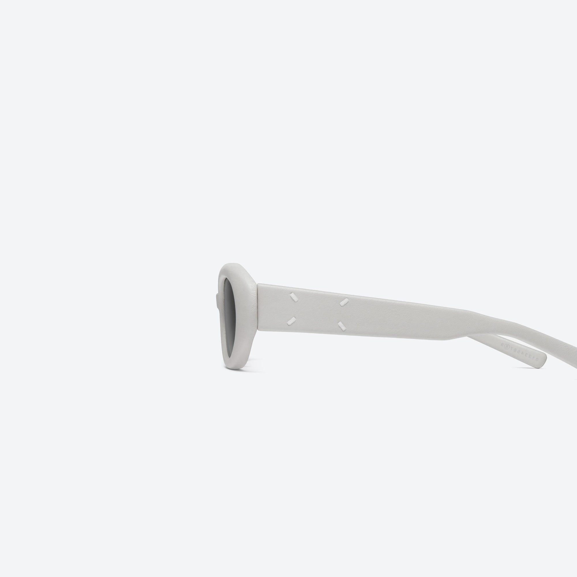 A detailed left view of Gentle Monster Maison Margiela - MM107 Leather LIV1 Ivory Acetate framed Oval sunglasses.
