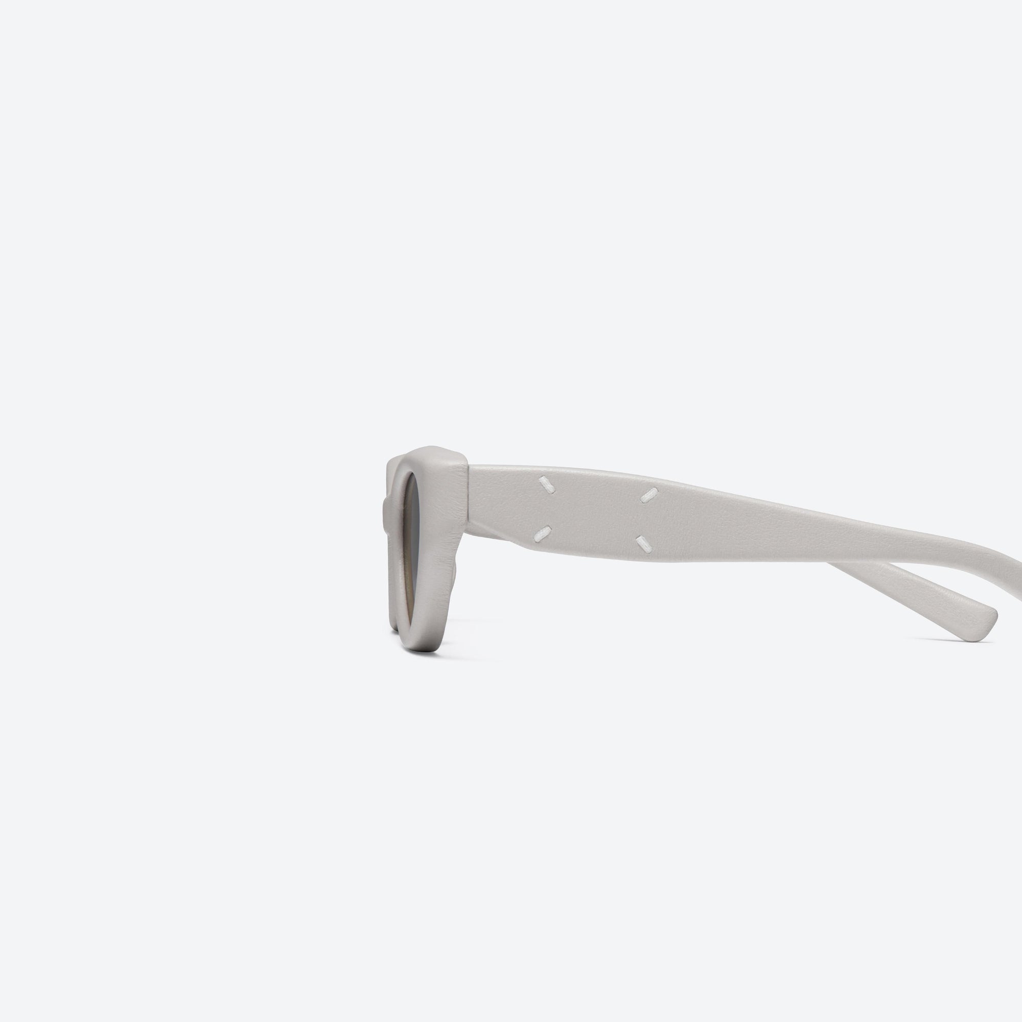 A detailed left view of Gentle Monster Maison Margiela - MM108 Leather LIV1 Ivory Acetate framed Cat-eye sunglasses.