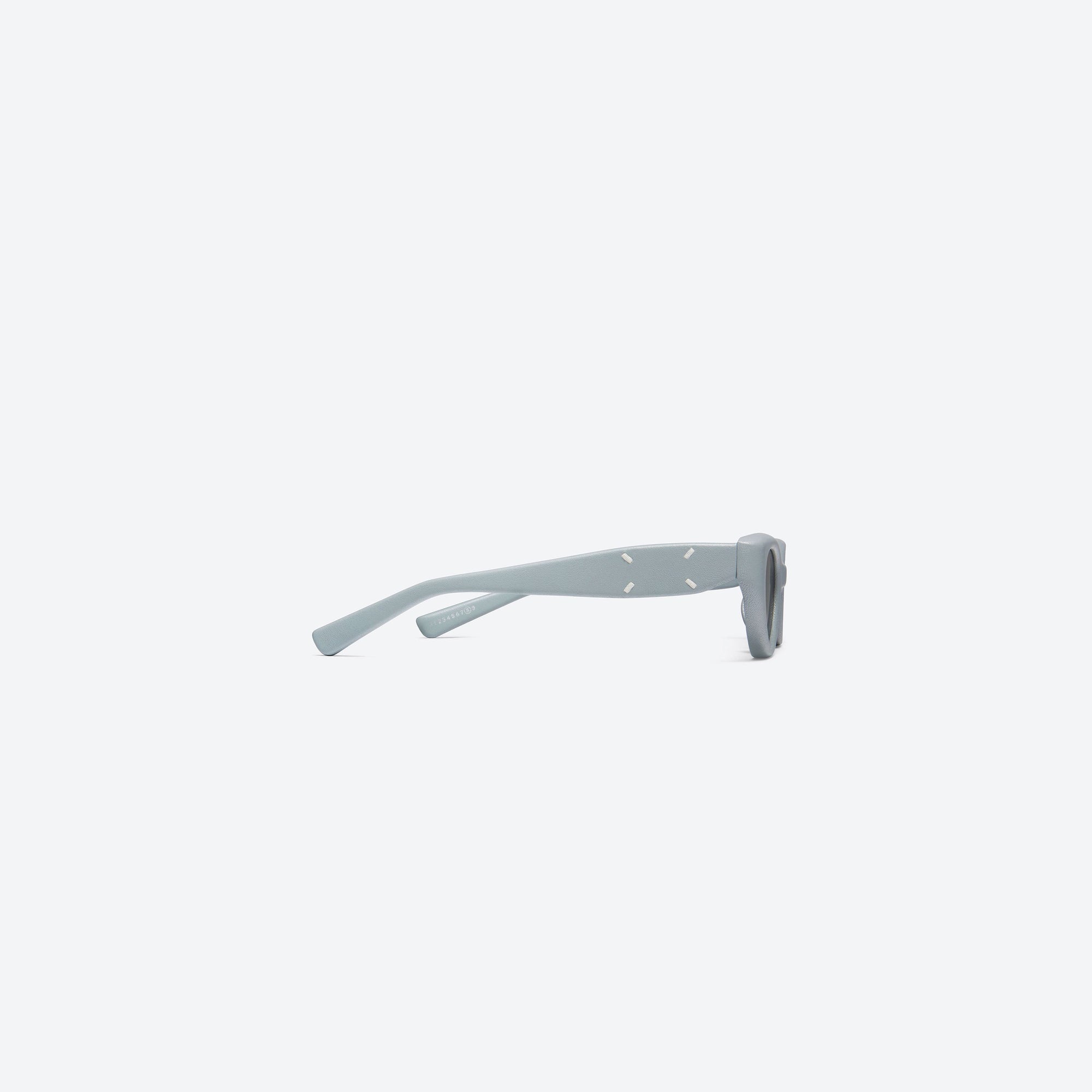 A detailed right view of Gentle Monster Maison Margiela - MM108 Leather LBL1 Blue Acetate framed Cat-eye sunglasses.