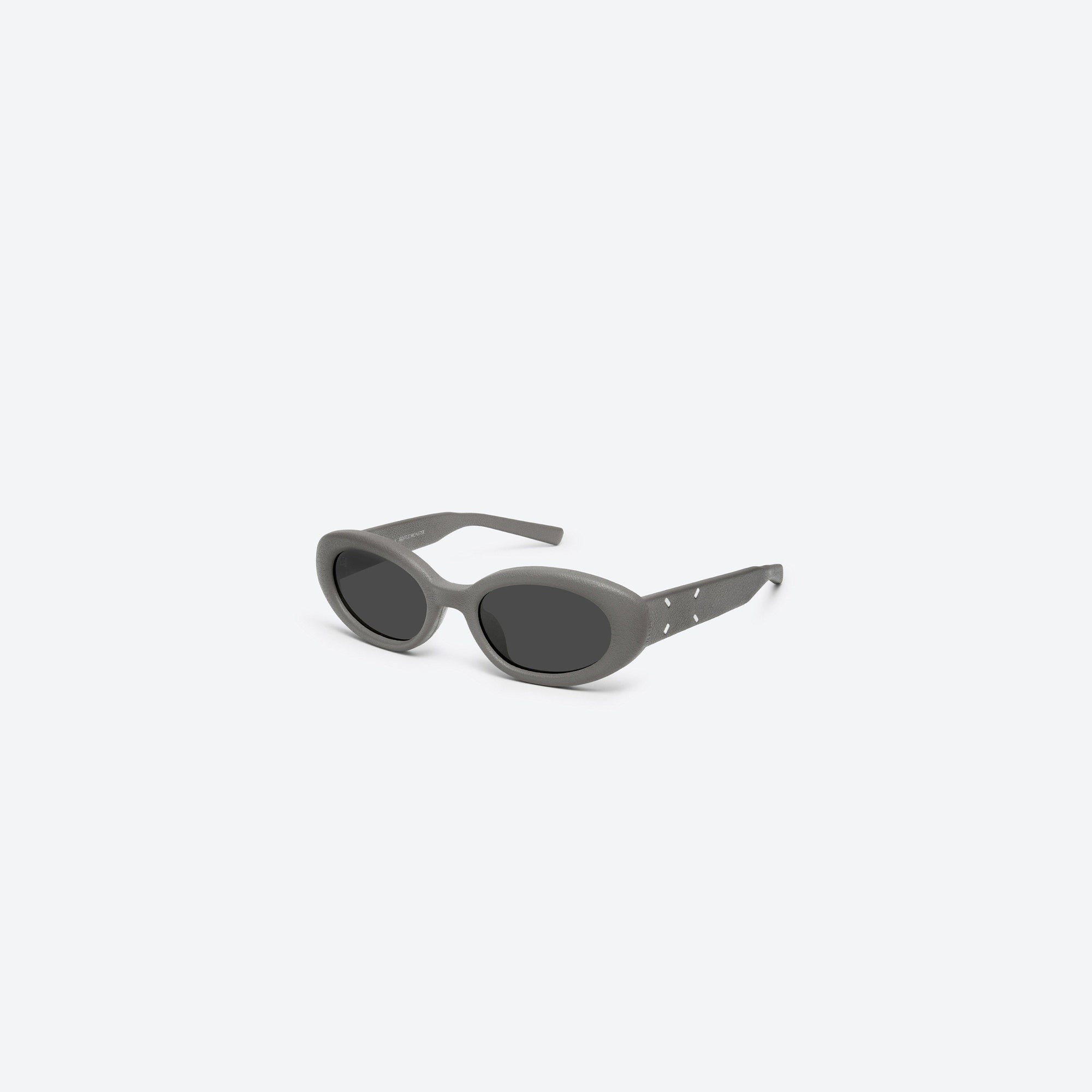 45-degree view of Gentle Monster Maison Margiela - MM107 Leather LK1 Green Acetate framed Oval sunglasses.