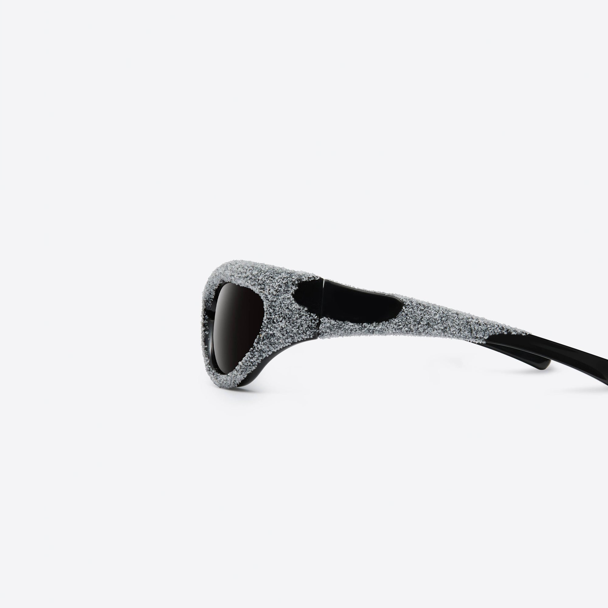 A detailed left view of Gentle Monster Yummy 01 Black Nylon framed Wraparound sunglasses.