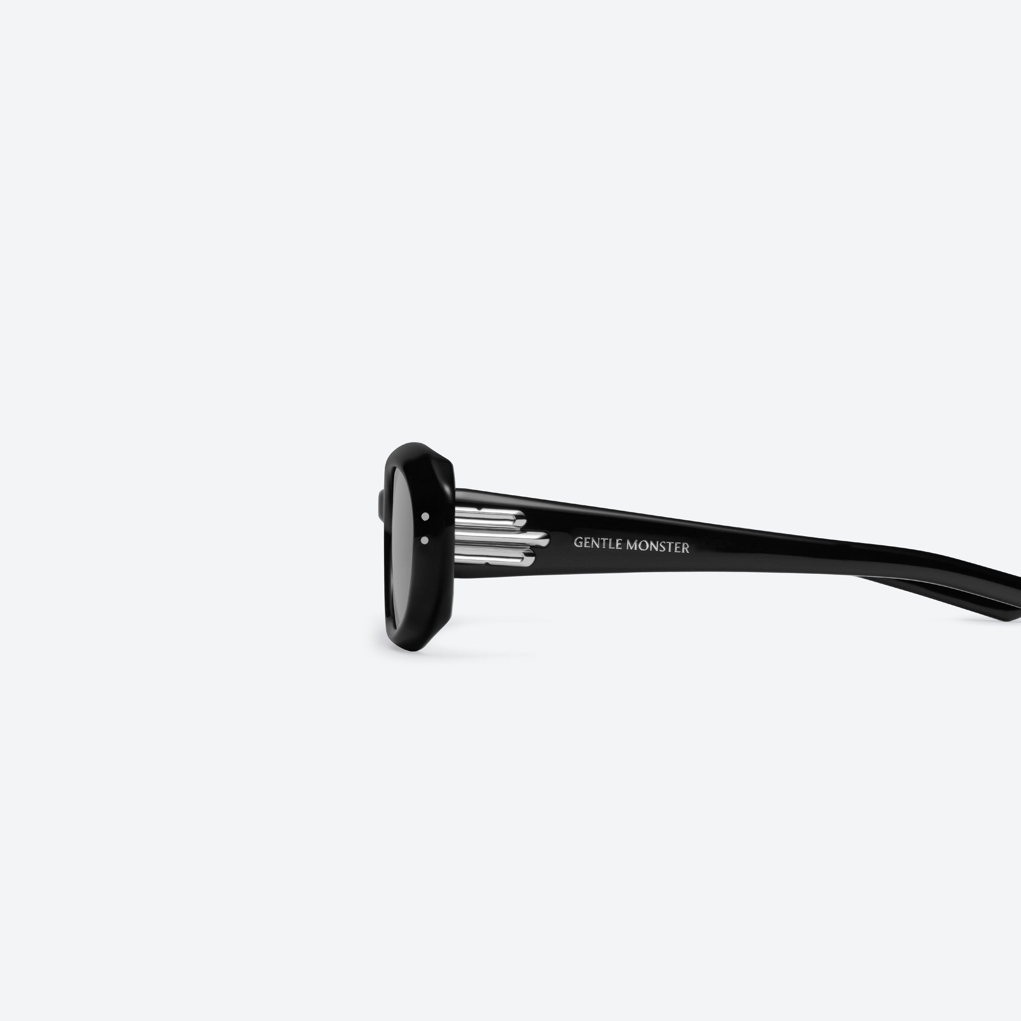 A detailed left view of Gentle Monster Blanc 01 Black Acetate framed Oval sunglasses.