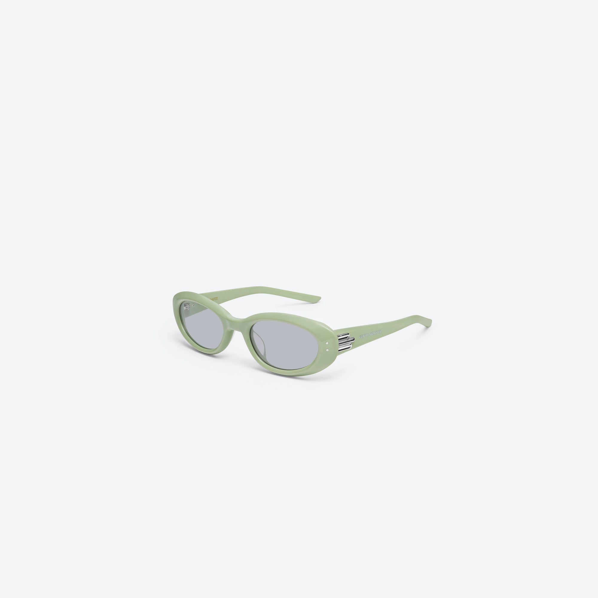45-degree view of Gentle Monster Blanc GR8 Green Acetate framed Oval sunglasses.