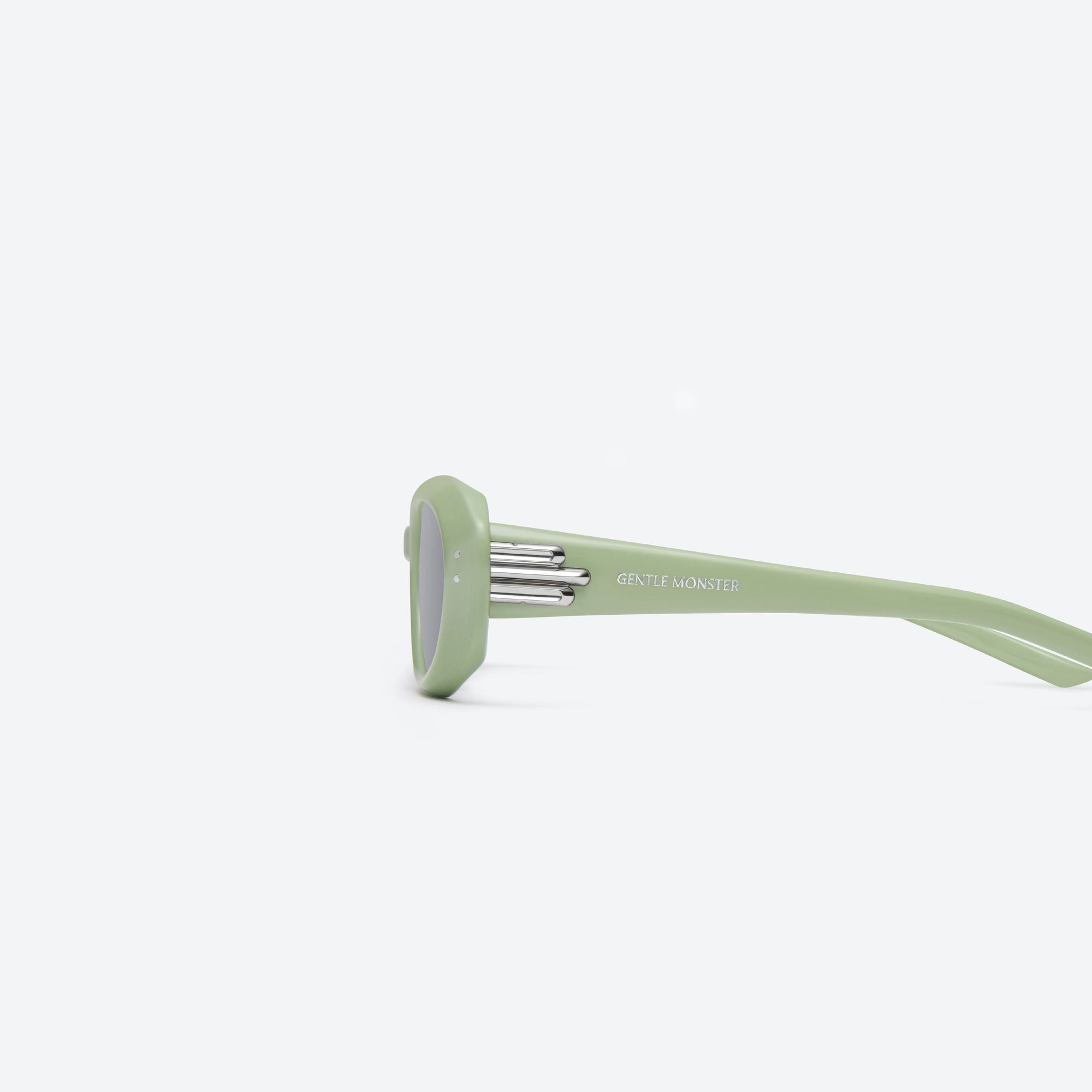 A detailed left view of Gentle Monster Blanc GR8 Green Acetate framed Oval sunglasses.