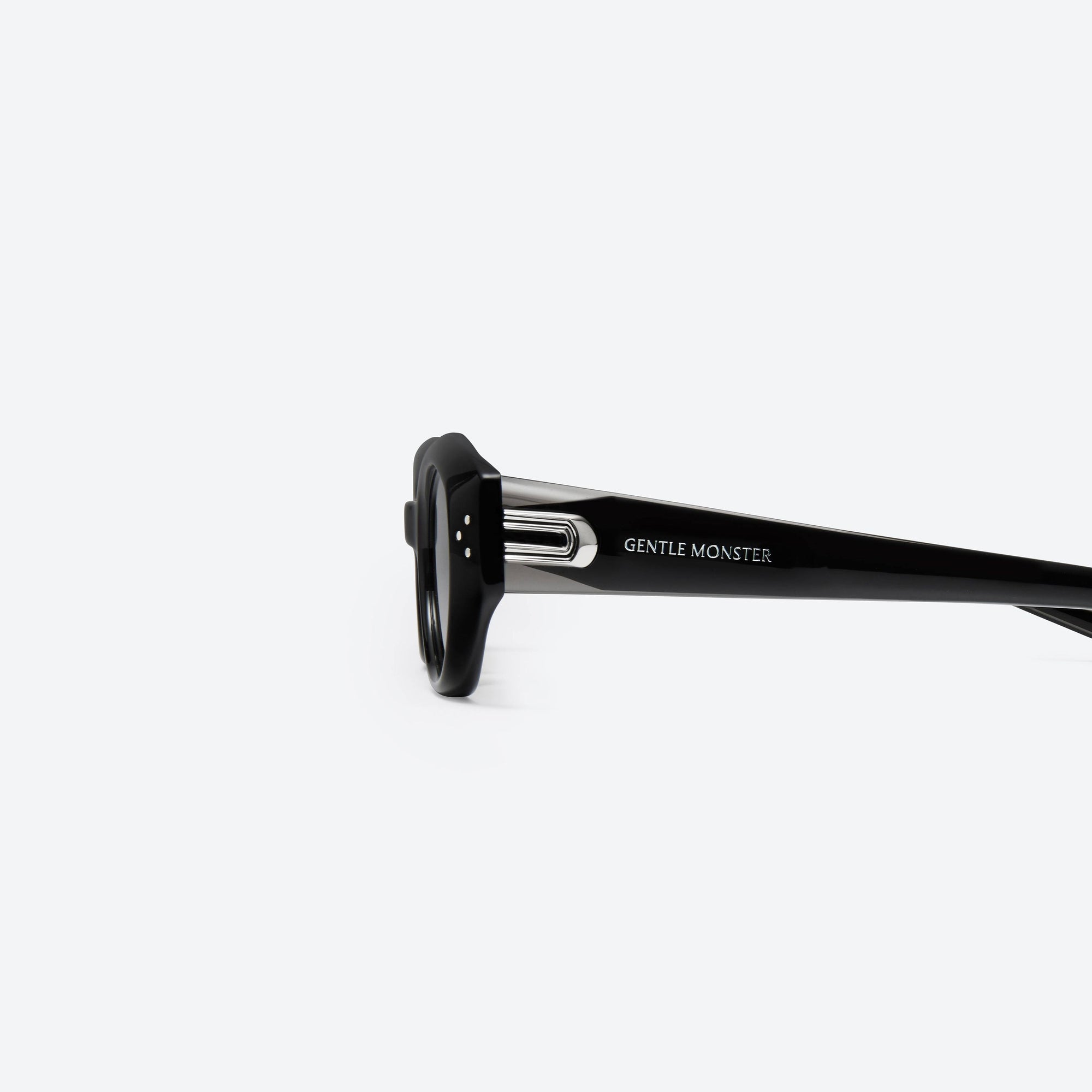 A detailed left view of Gentle Monster Dada 01 Black Acetate framed Oval sunglasses.