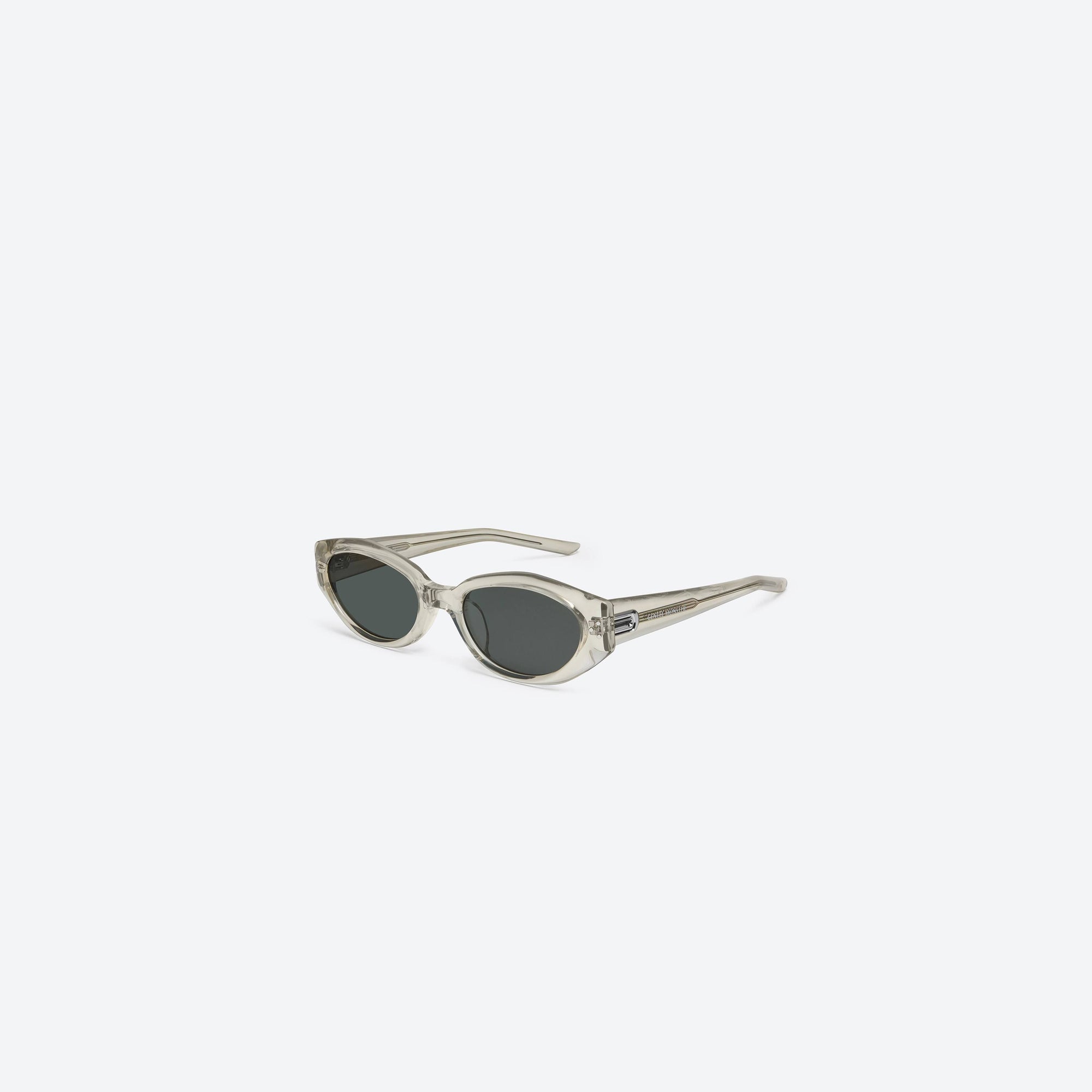 45-degree view of Gentle Monster Dada BRC11 Brown Acetate framed Oval sunglasses.