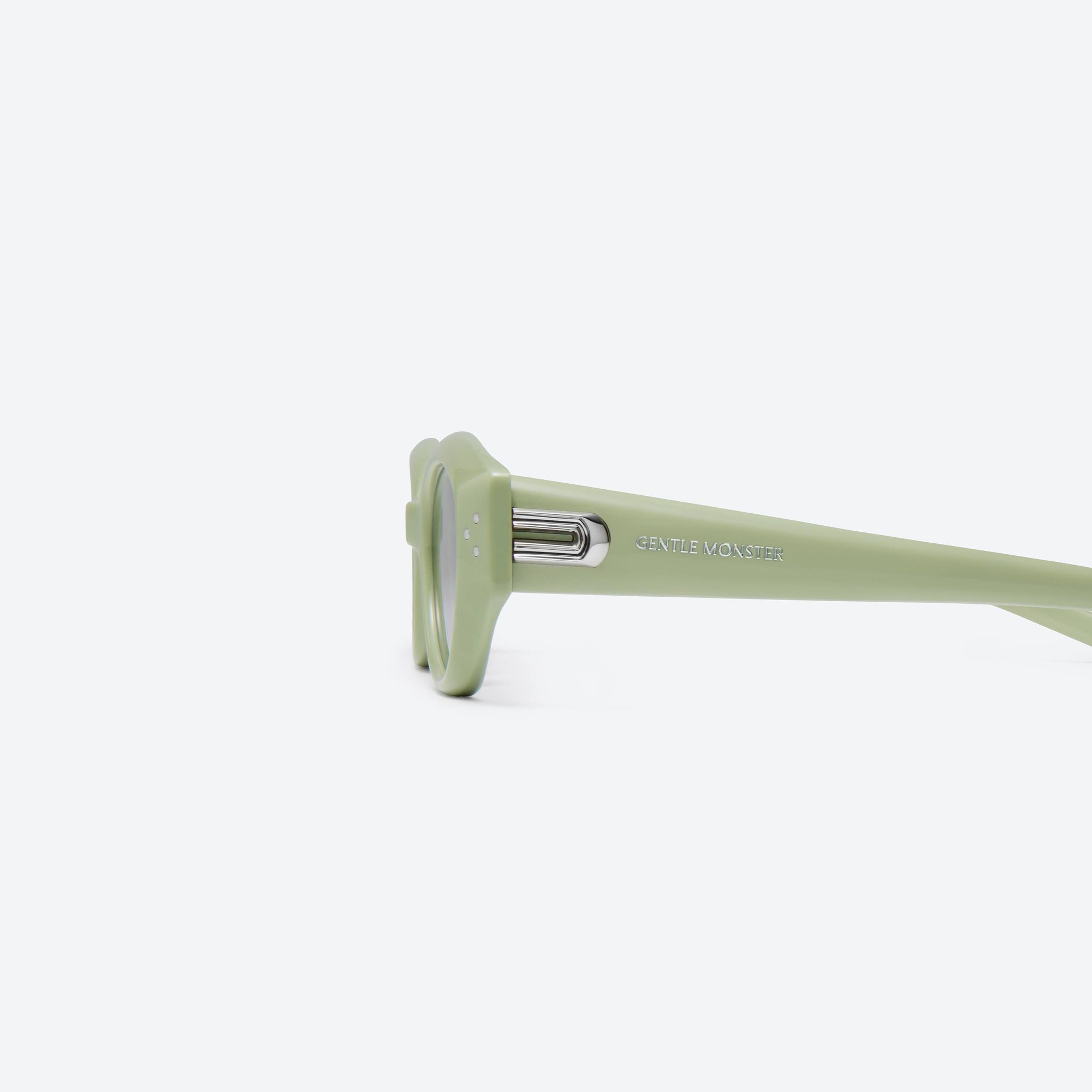 A detailed left view of Gentle Monster Dada GR8 Green Acetate framed Oval sunglasses.