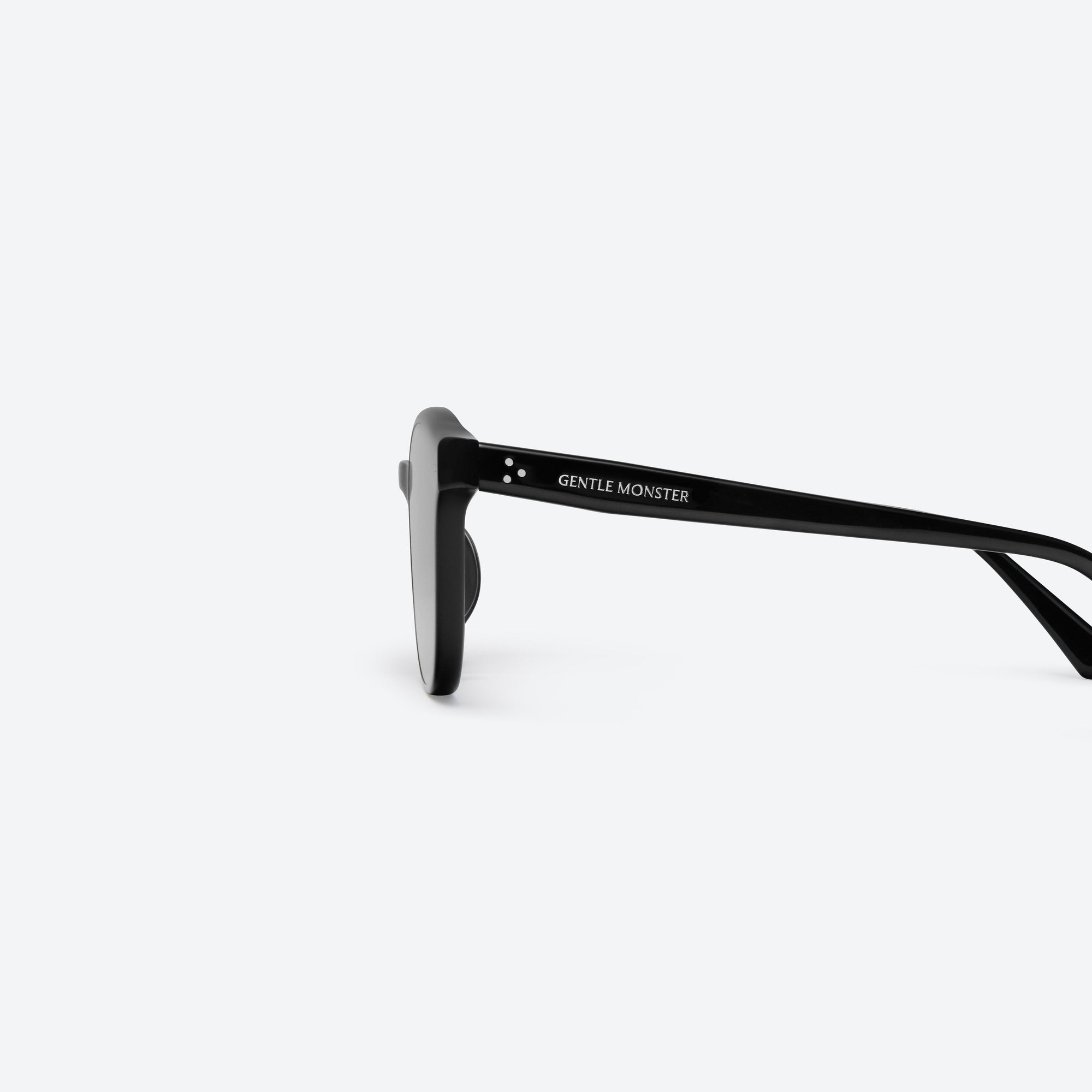 A detailed left view of Gentle Monster Jade 01 Black Acetate framed Round sunglasses.