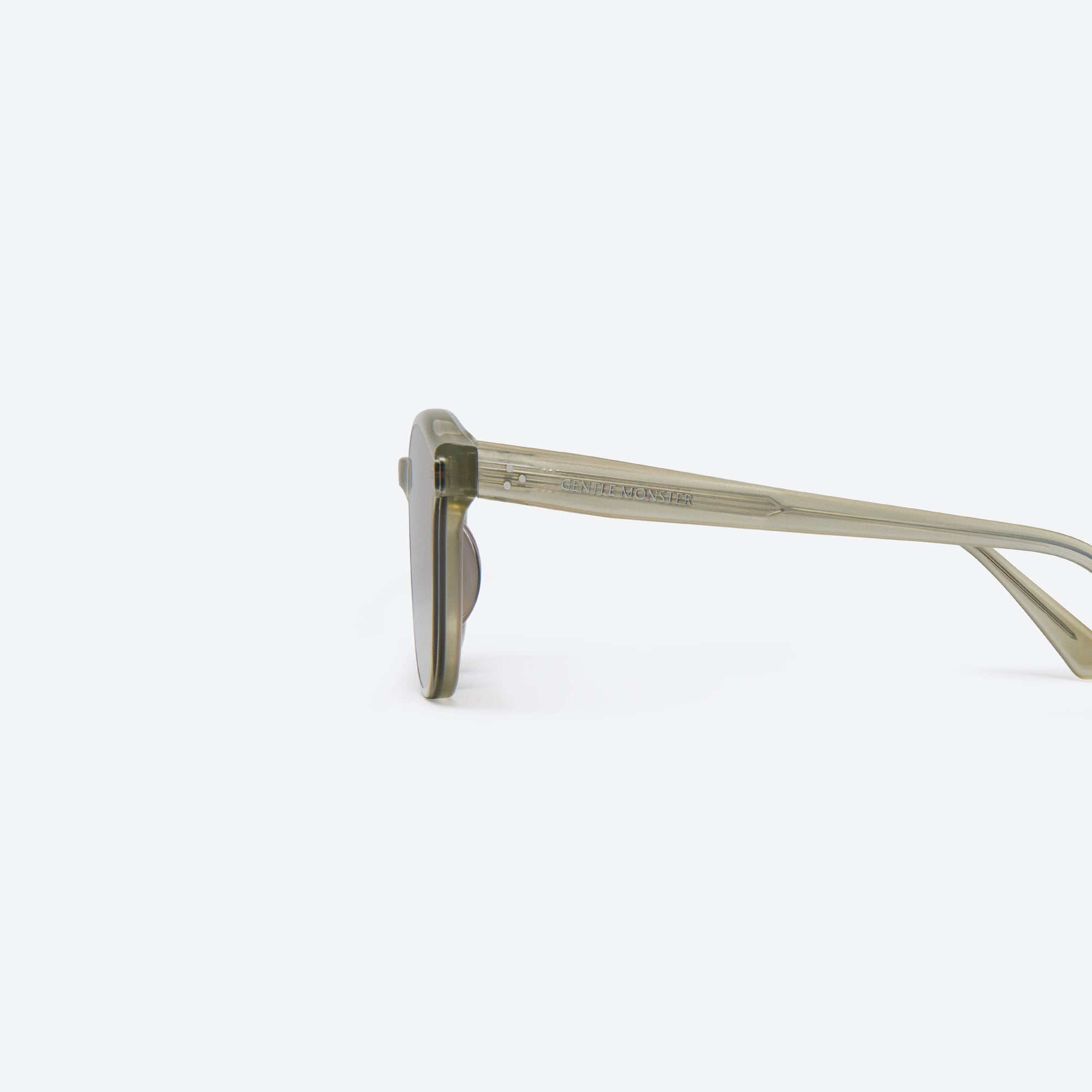 A detailed left view of Gentle Monster Jade GC10 Gray Acetate framed Round sunglasses.