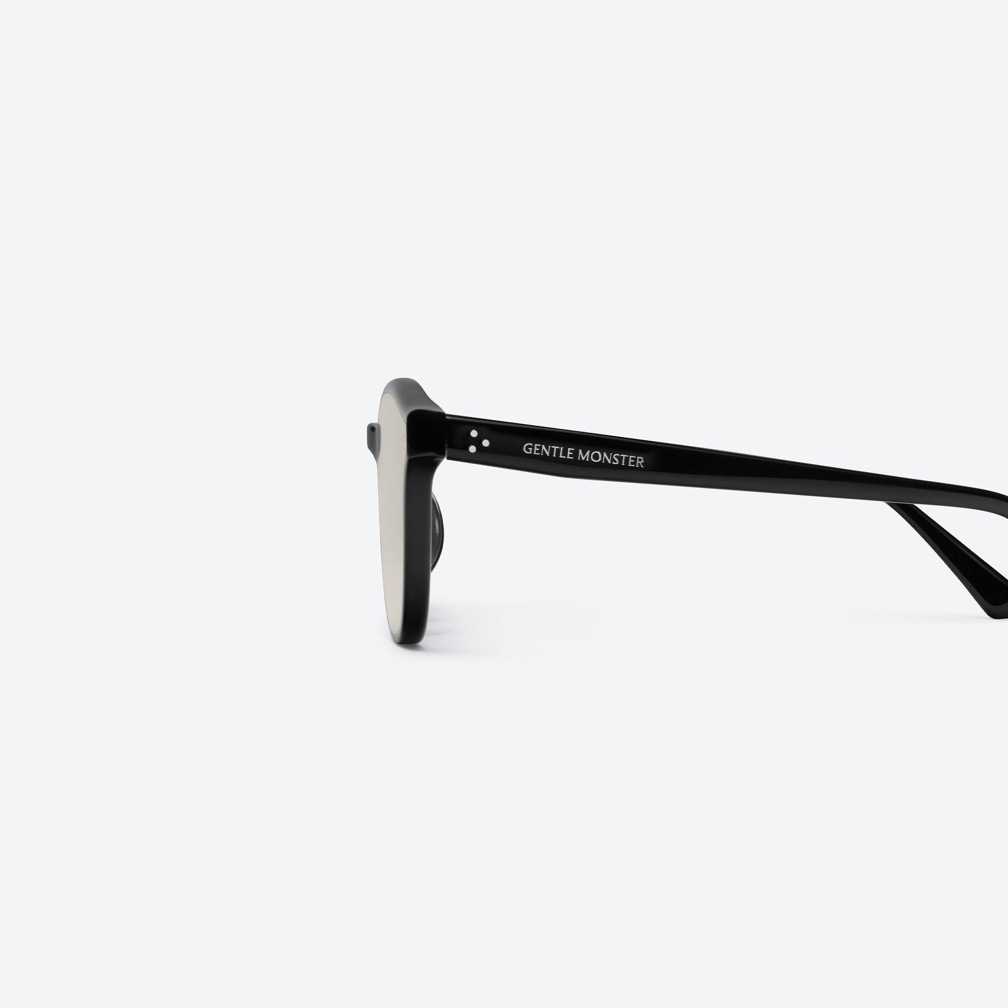 A detailed left view of Gentle Monster Jade 01(BR) Black Acetate framed Round sunglasses.