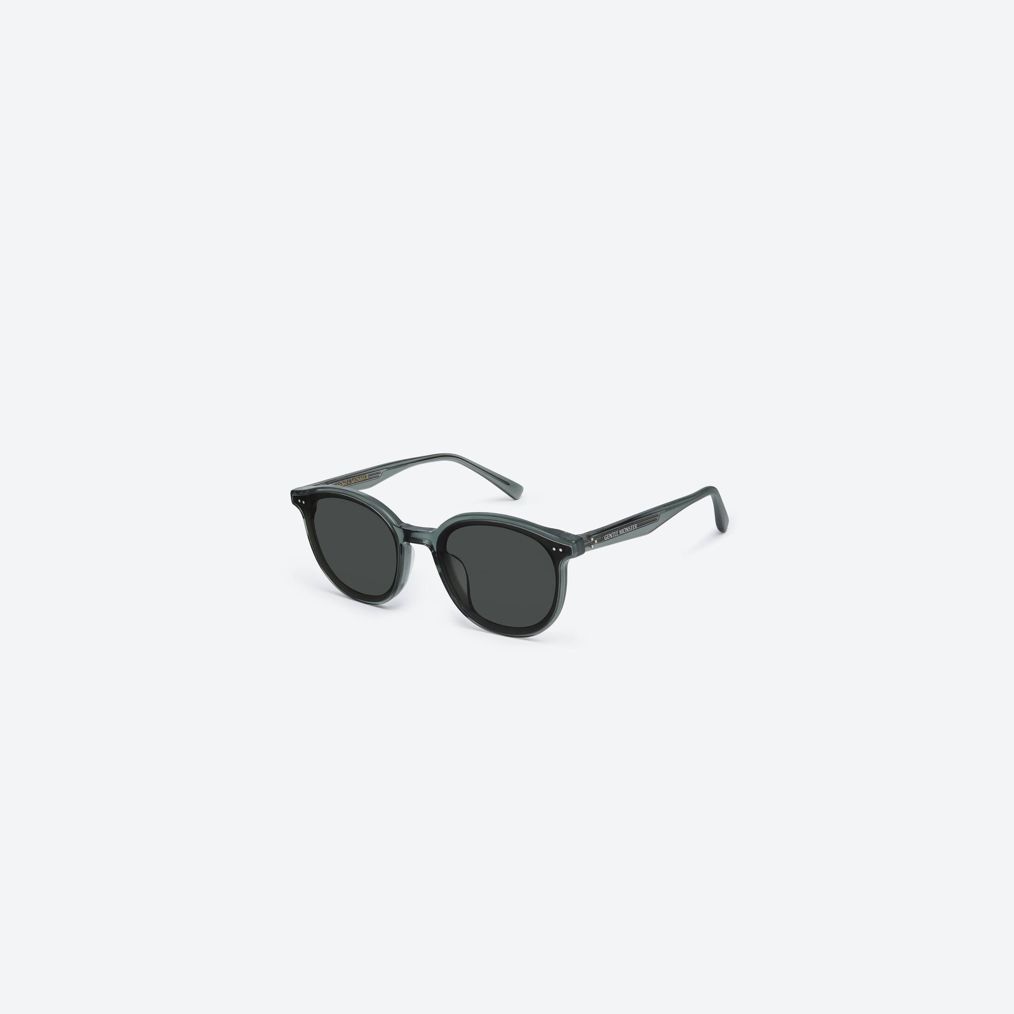 45-degree view of Gentle Monster New Born G3 Gray Acetate framed Round sunglasses.