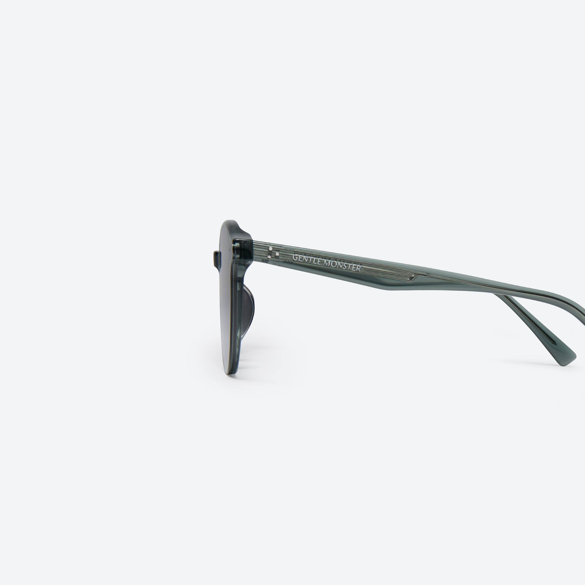 A detailed left view of Gentle Monster New Born G3 Gray Acetate framed Round sunglasses.