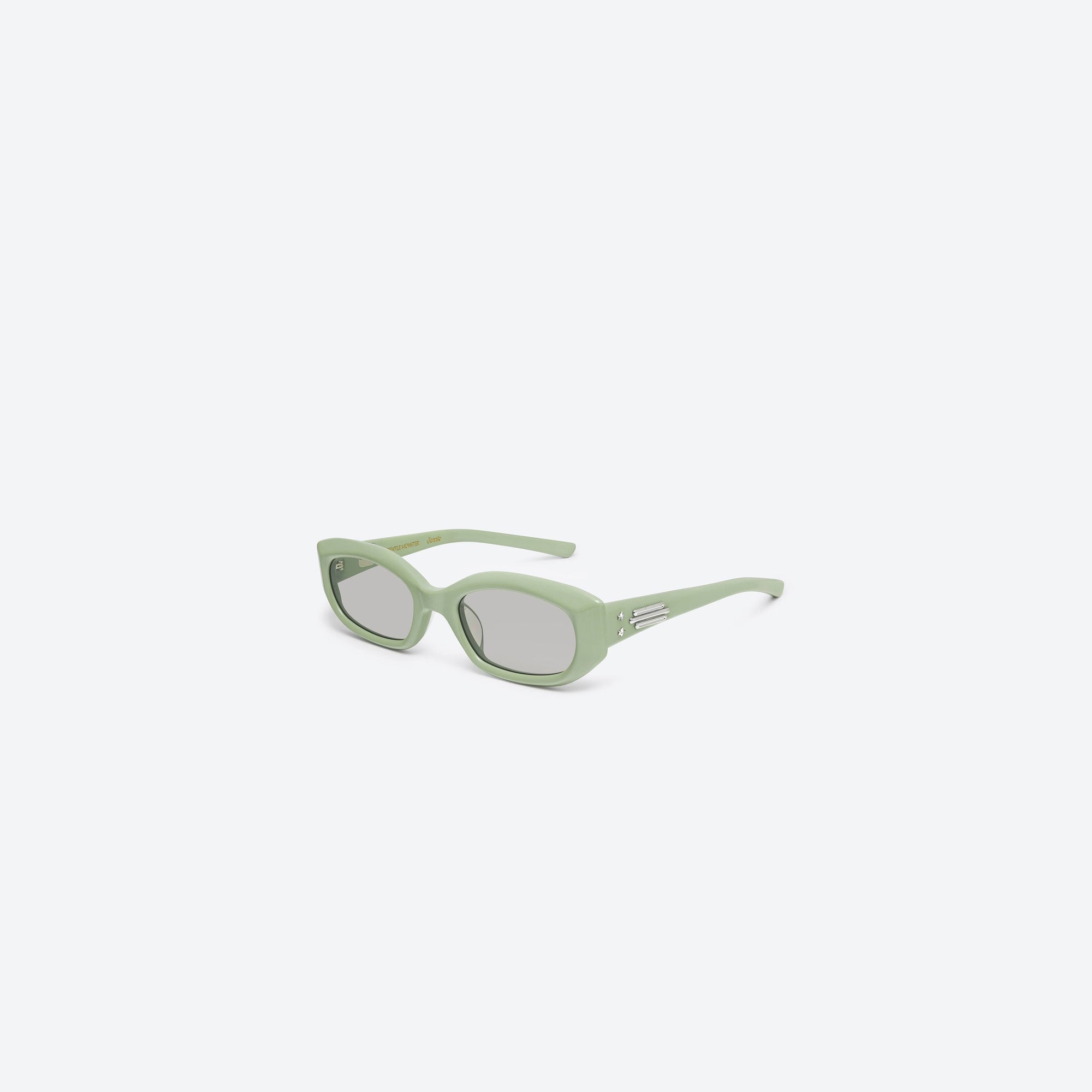 45-degree view of Gentle Monster Jennie - Wispy GR8 Green Acetate framed Square sunglasses.