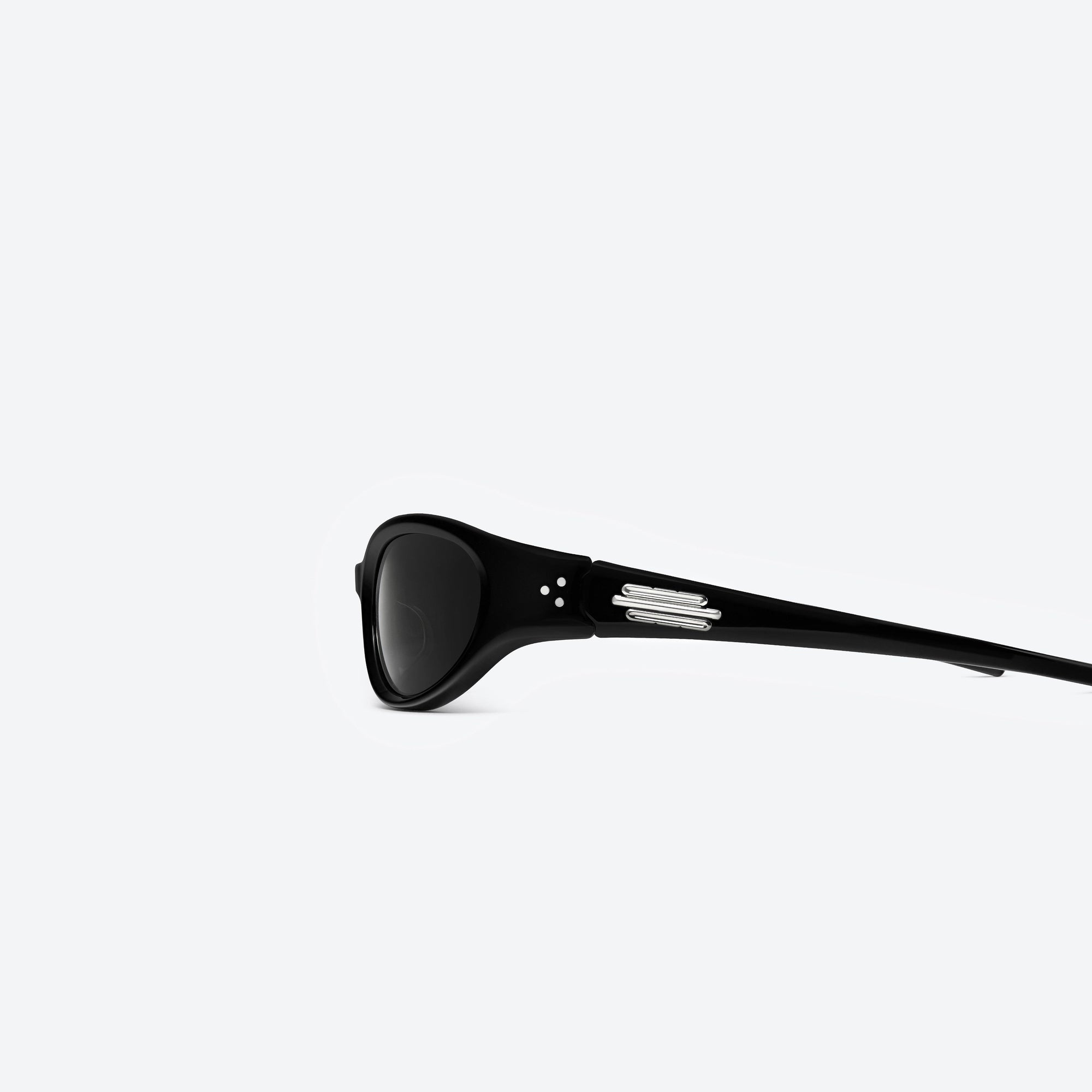 A detailed left view of Gentle Monster Jennie - Donut Bun 01 Black Acetate framed Wraparound sunglasses.