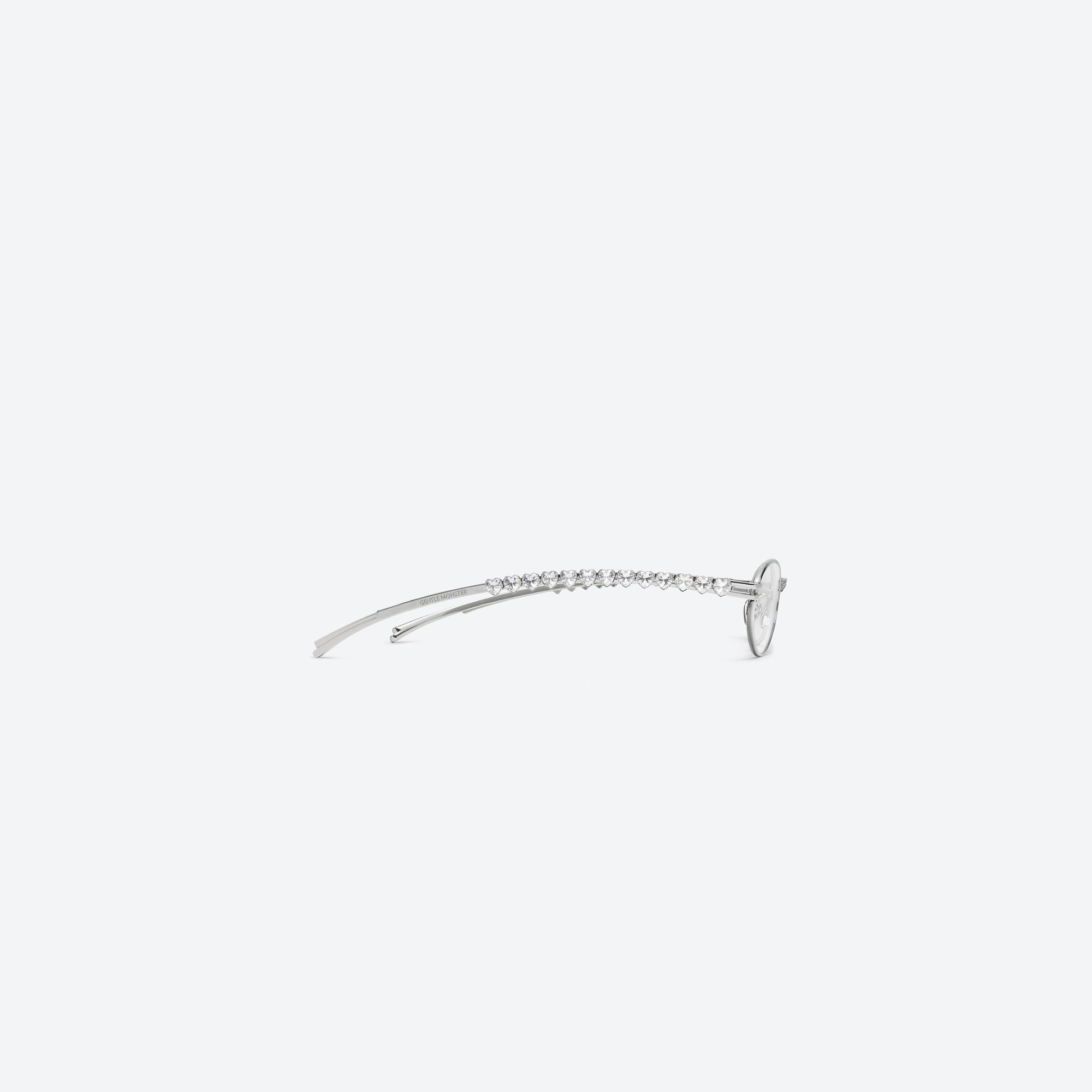 A detailed right view of Gentle Monster Jennie - Barrette 02 Silver Metal framed Oval sunglasses.