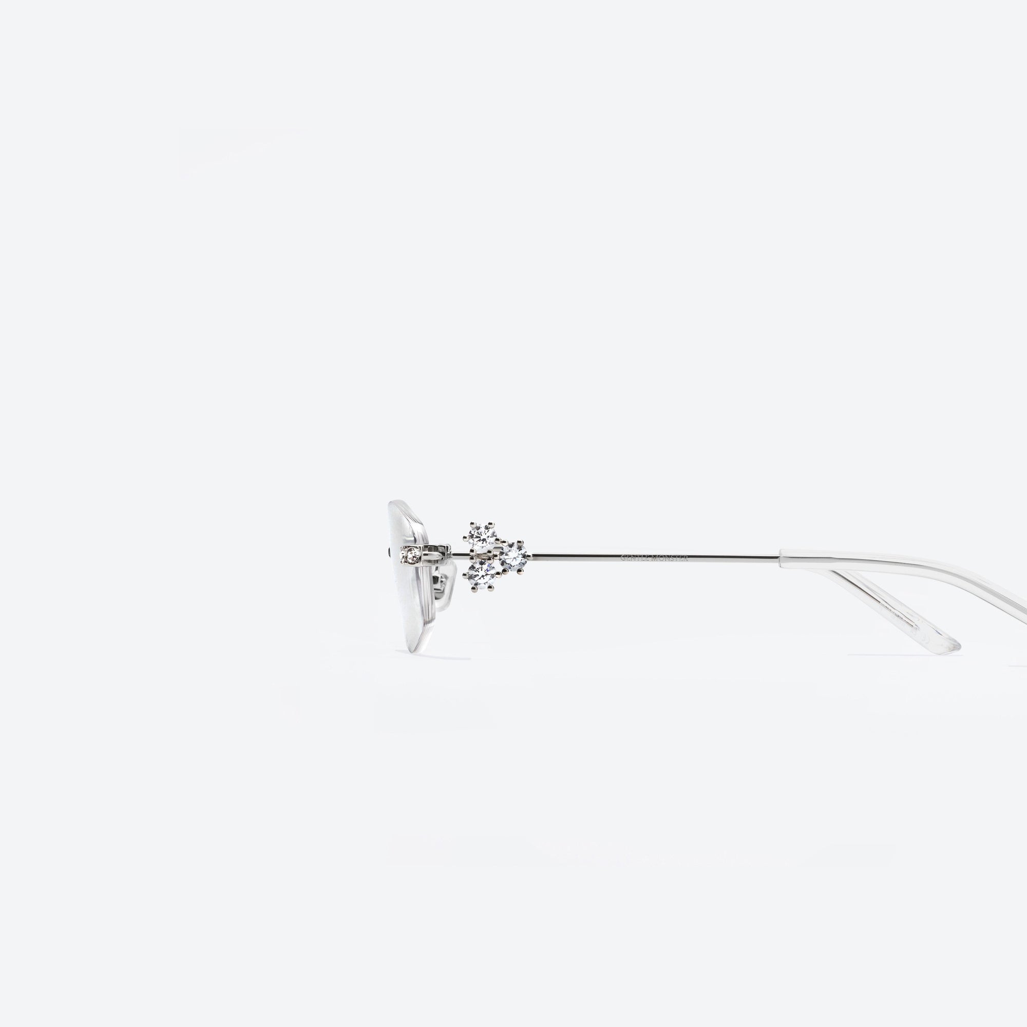 A detailed left view of Gentle Monster Glitz 02 Silver Metal framed Oval sunglasses.