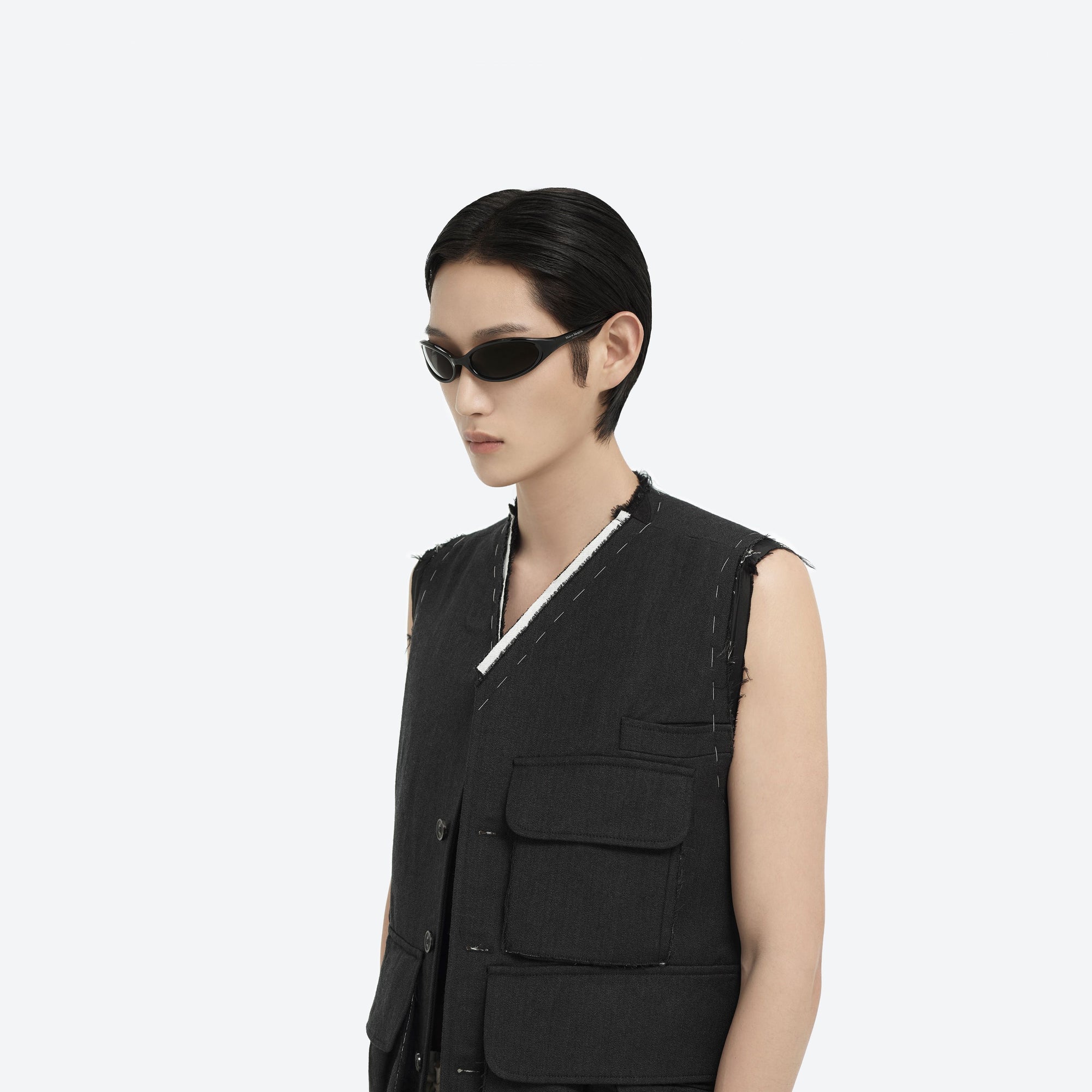Model wearing the Maison Margiela - MM202 01 Black Acetate framed Wraparound sunglasses.