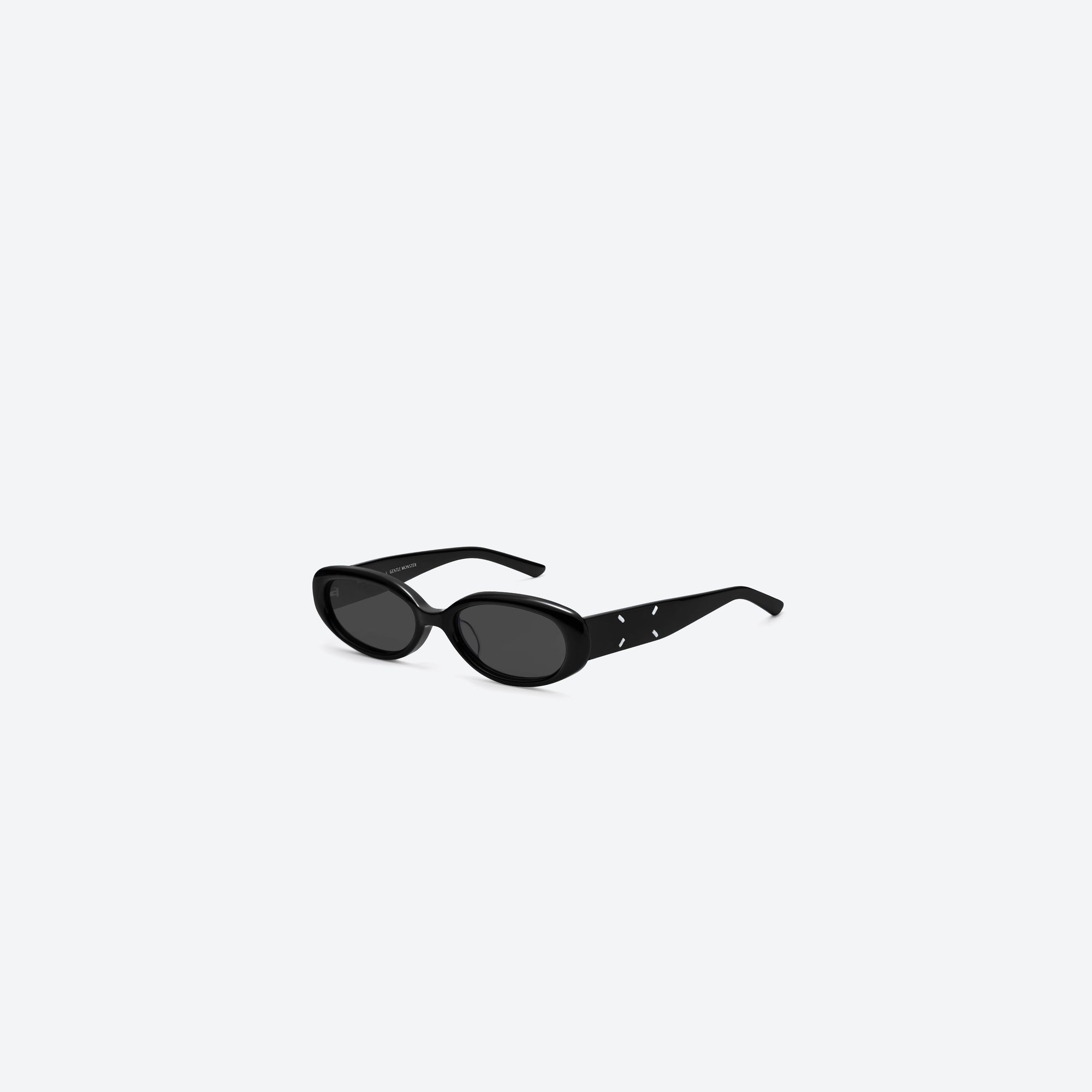 45-degree view of Gentle Monster Maison Margiela - MM206 01 Black Acetate framed Oval sunglasses.