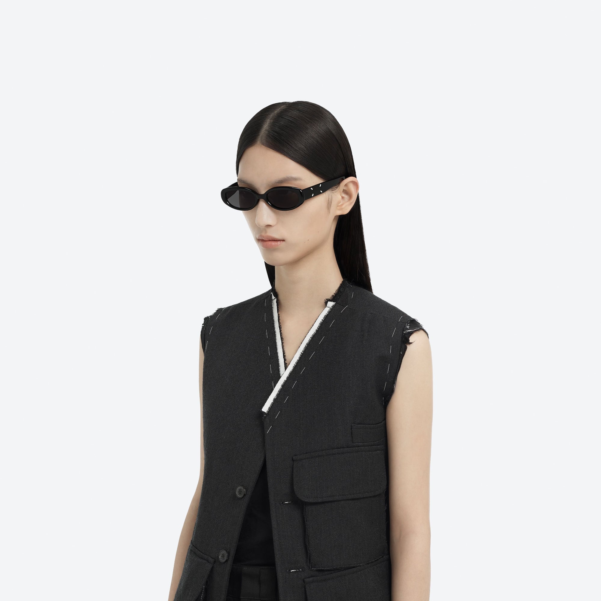 Model wearing the Maison Margiela - MM206 01 Black Acetate framed Oval sunglasses.
